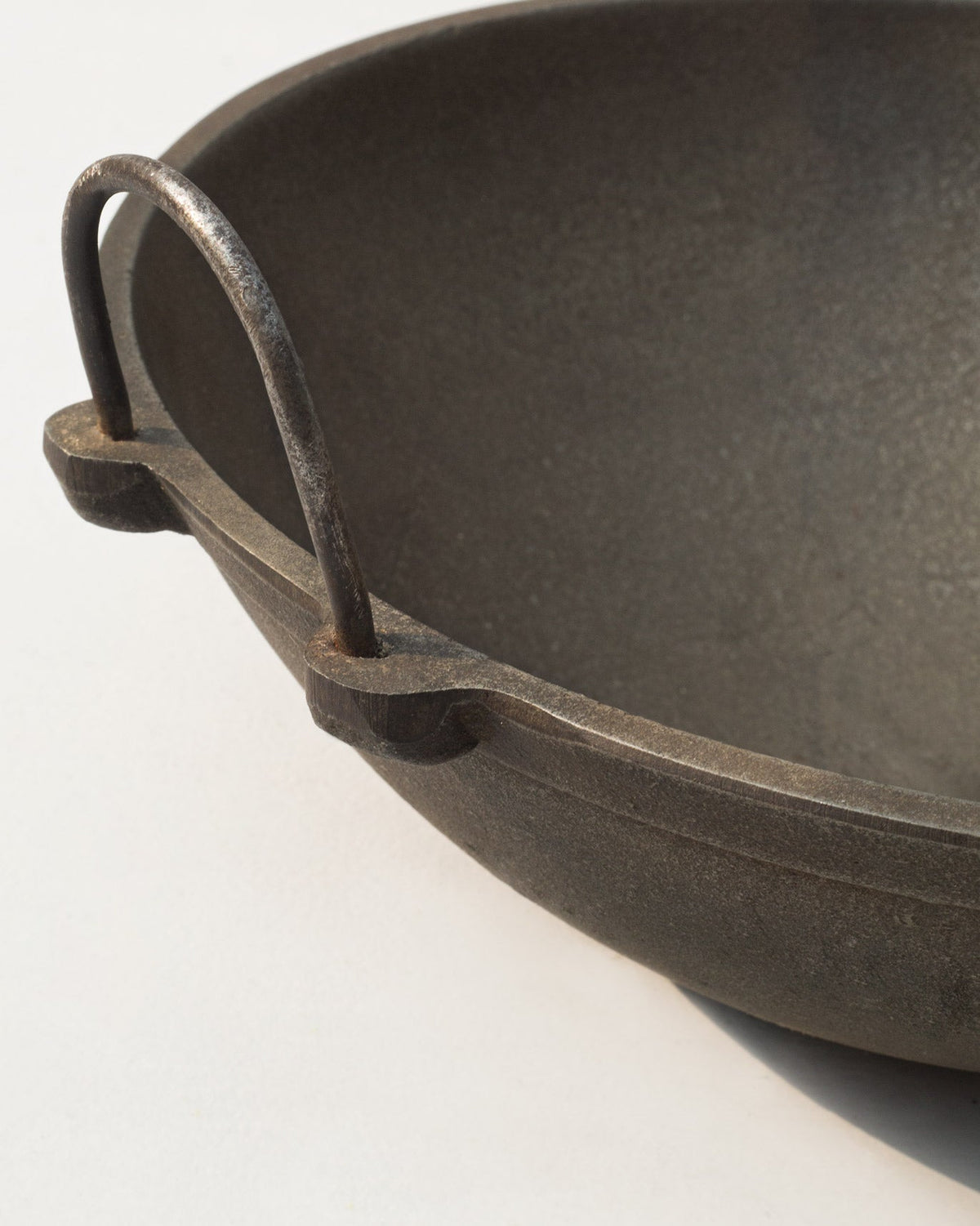 Close-up of the Cast Iron Kadai rim and loop handle.