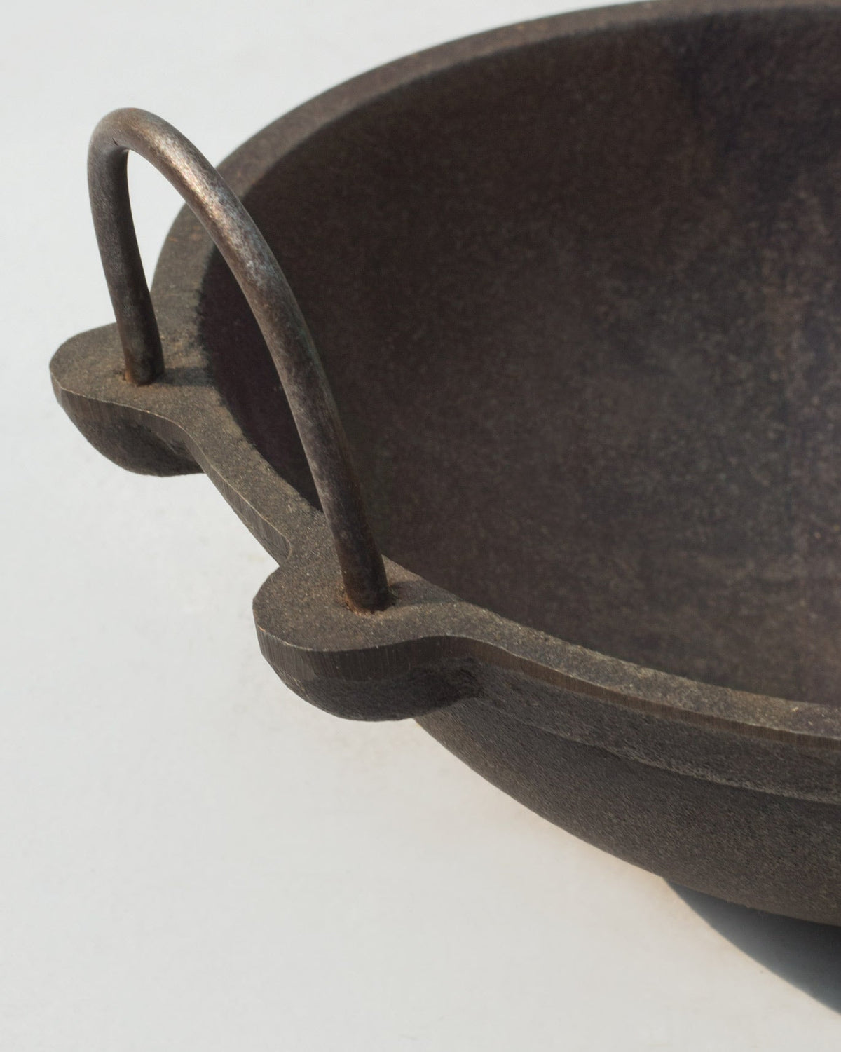 Close-up of the Cast Iron Kadai handle joint on its rim.
