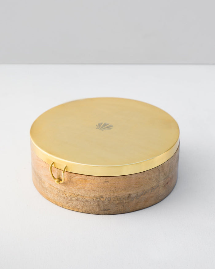 Diamantina Spice Box with a gold lid and shell motif.