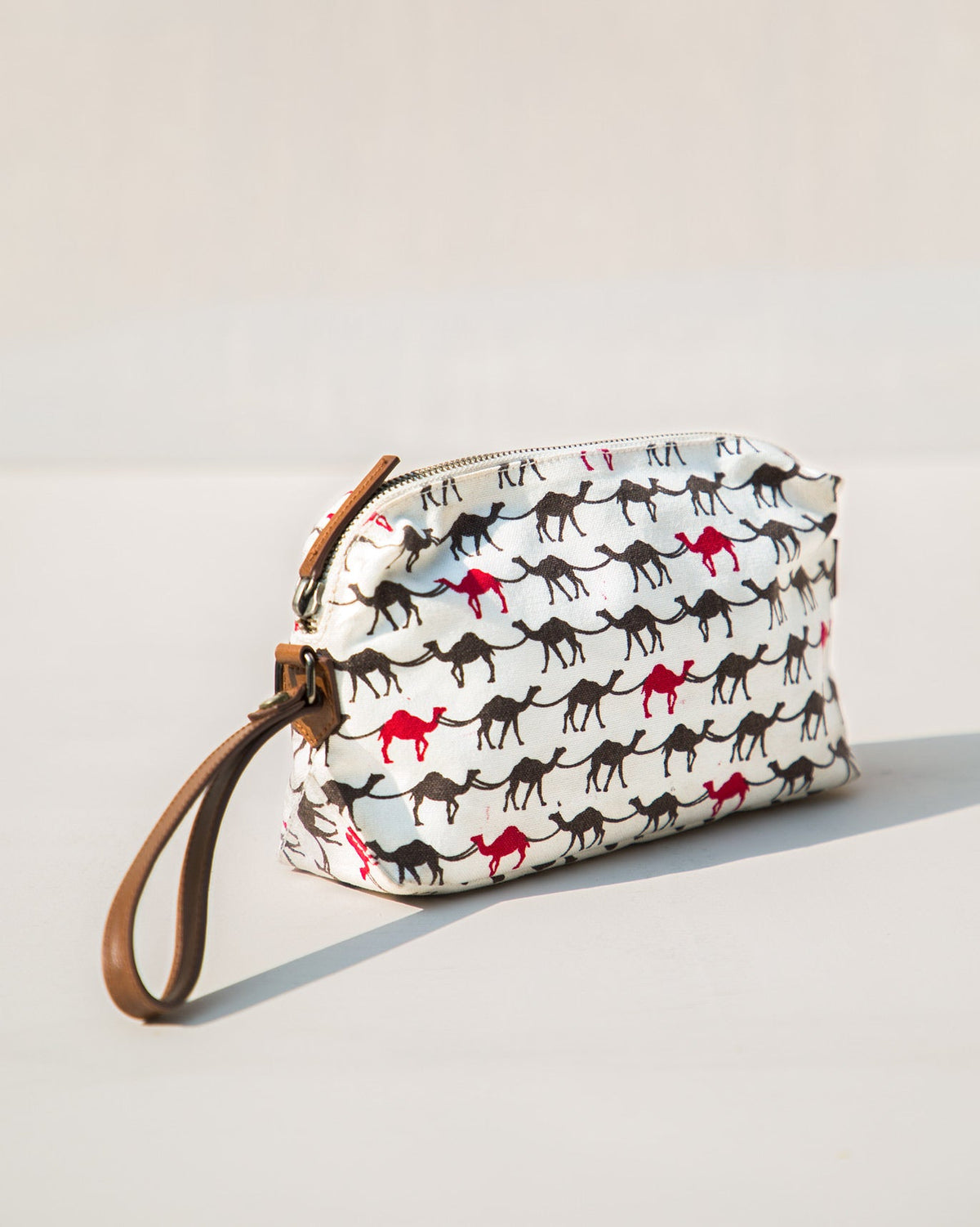 Side view of a Camel Make-up Pouch showing its zip and wrist strap.