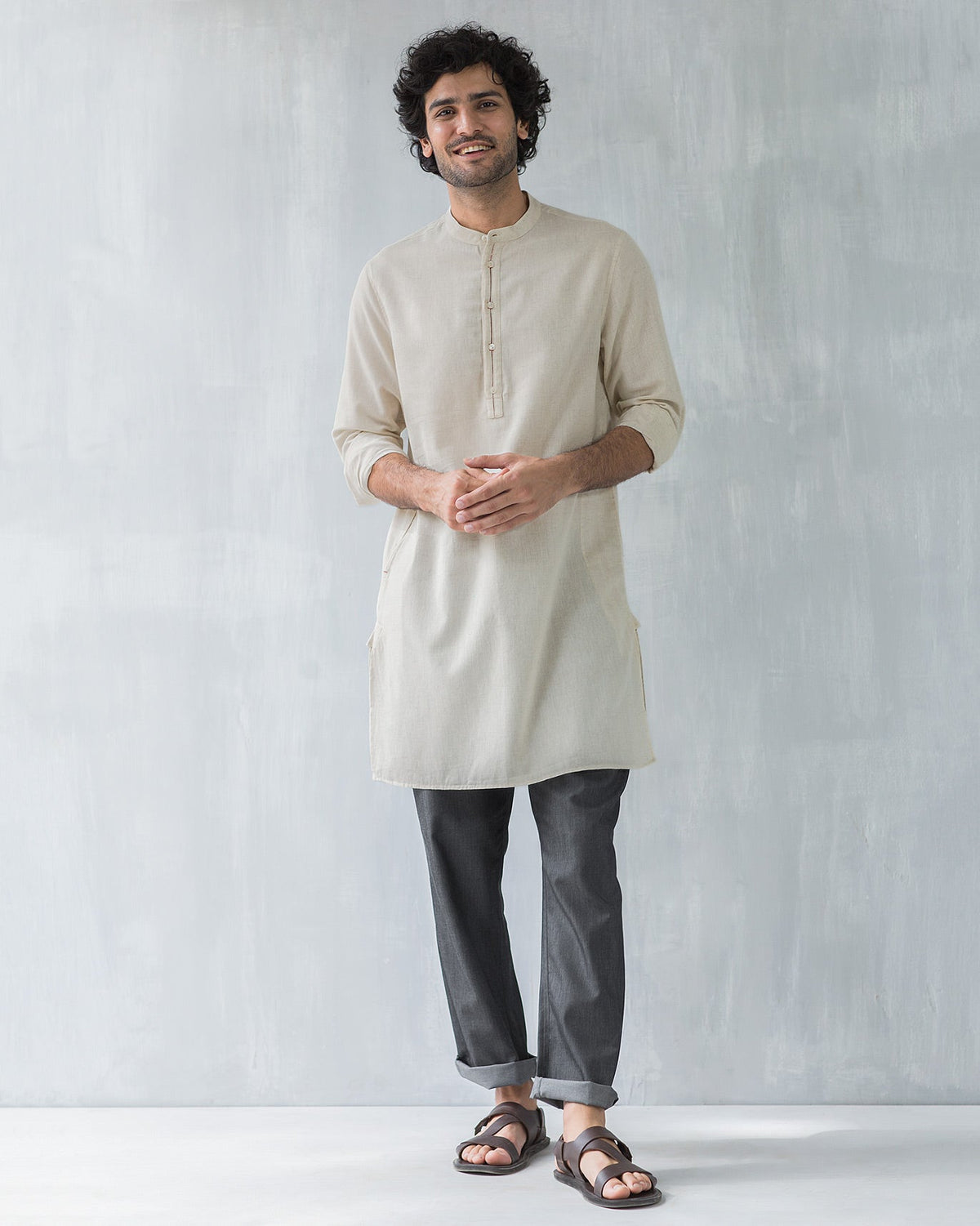 Person wearing a beige Chandni Chowk kurta.