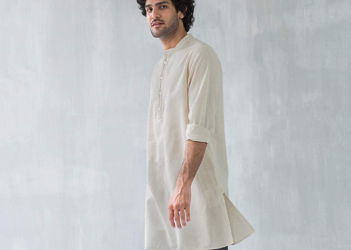 Side view of a beige Chandni Chowk kurta worn by a person.