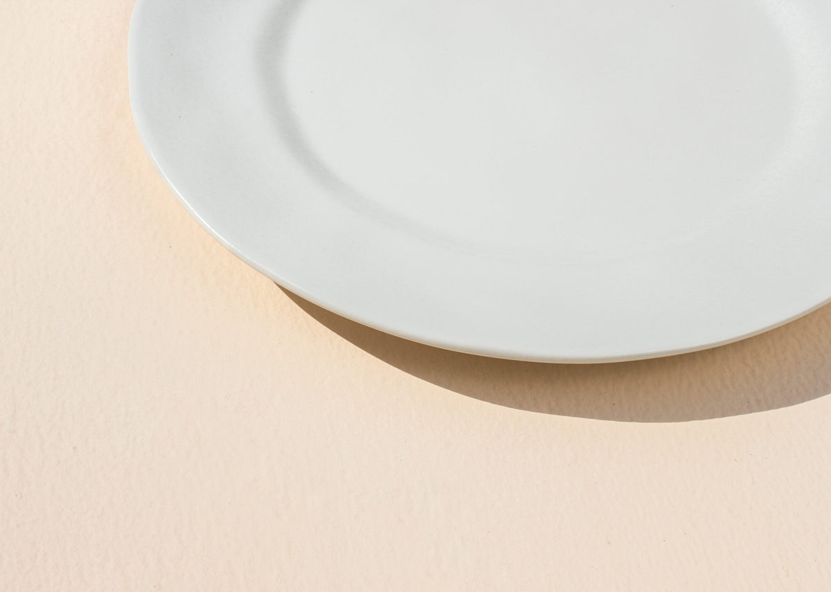 Close-up of the edge of a Desert Dawn Dinner Plate in ivory.