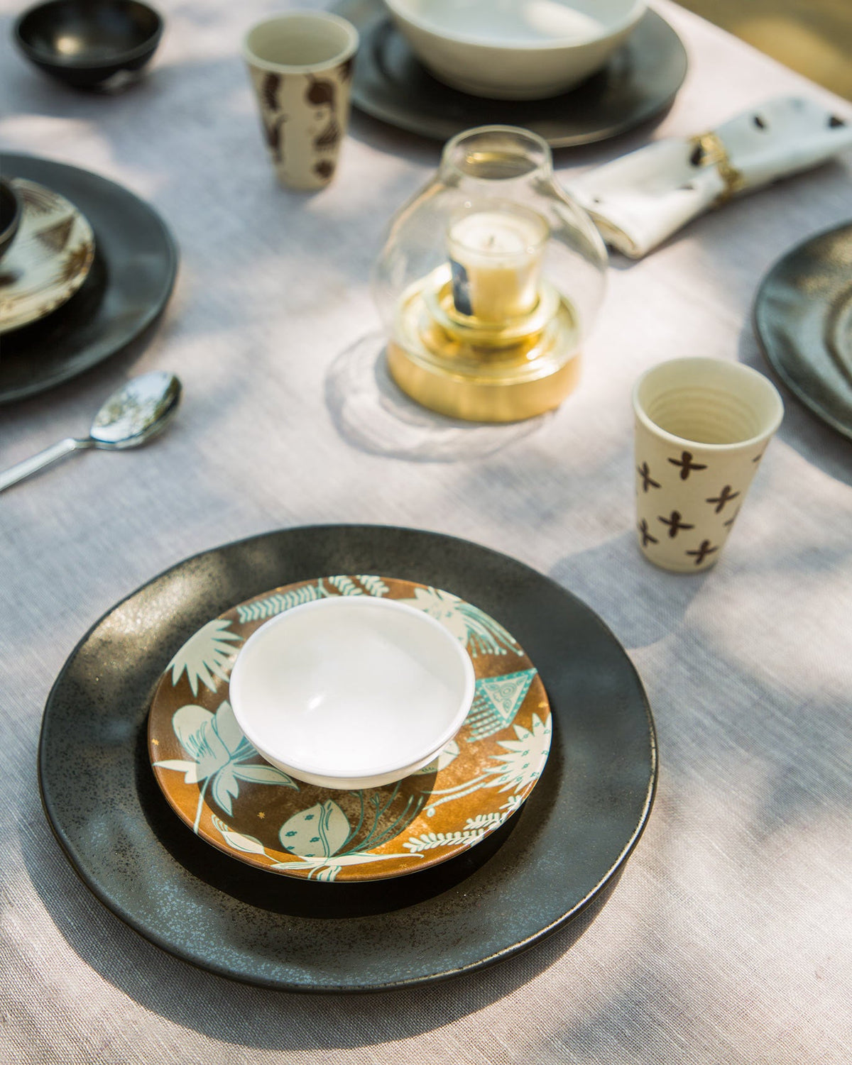 Desert Dawn Katori in ivory set on a dark plate.
