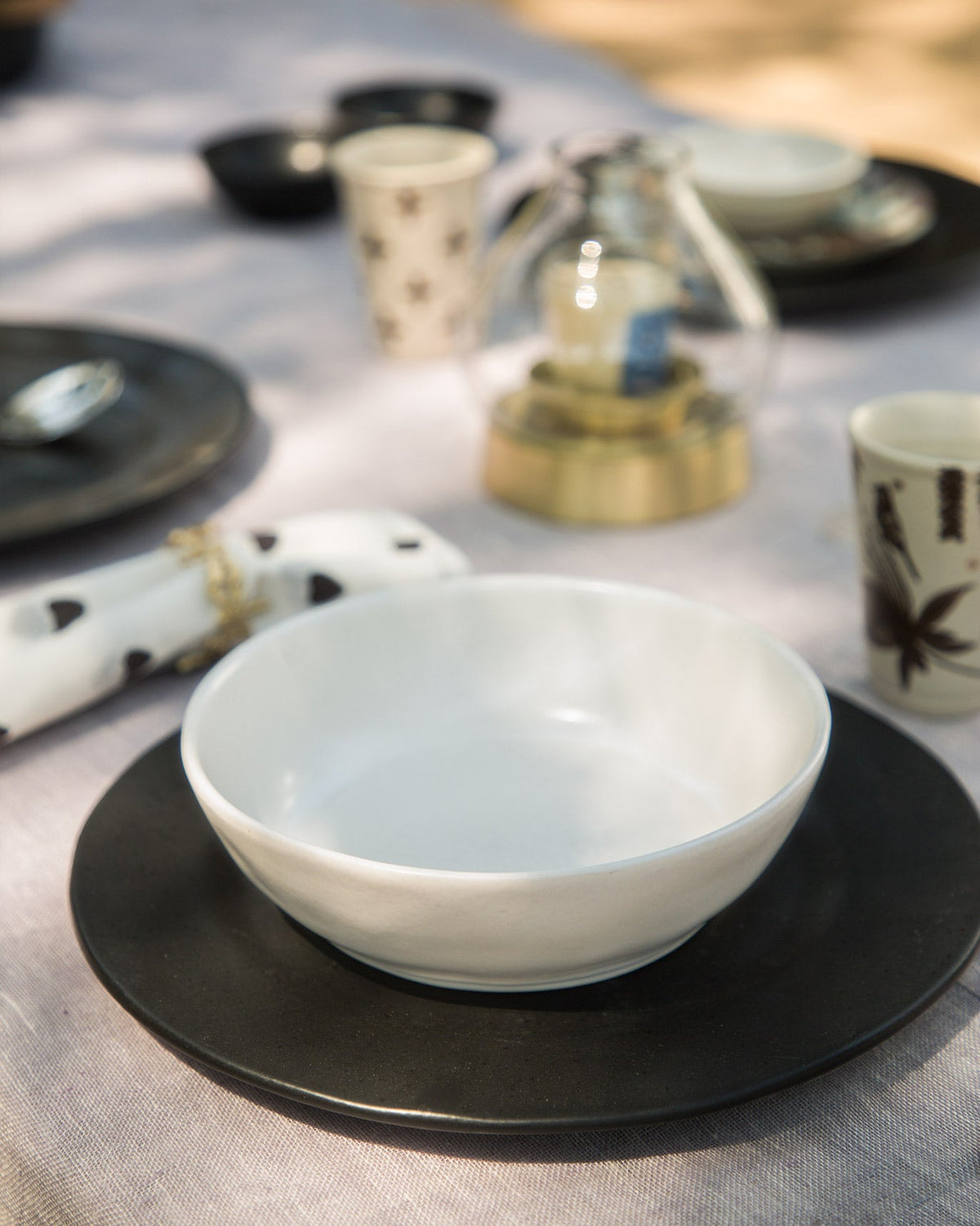 Desert Dawn Pasta Plate in ivory set on a dark plate.