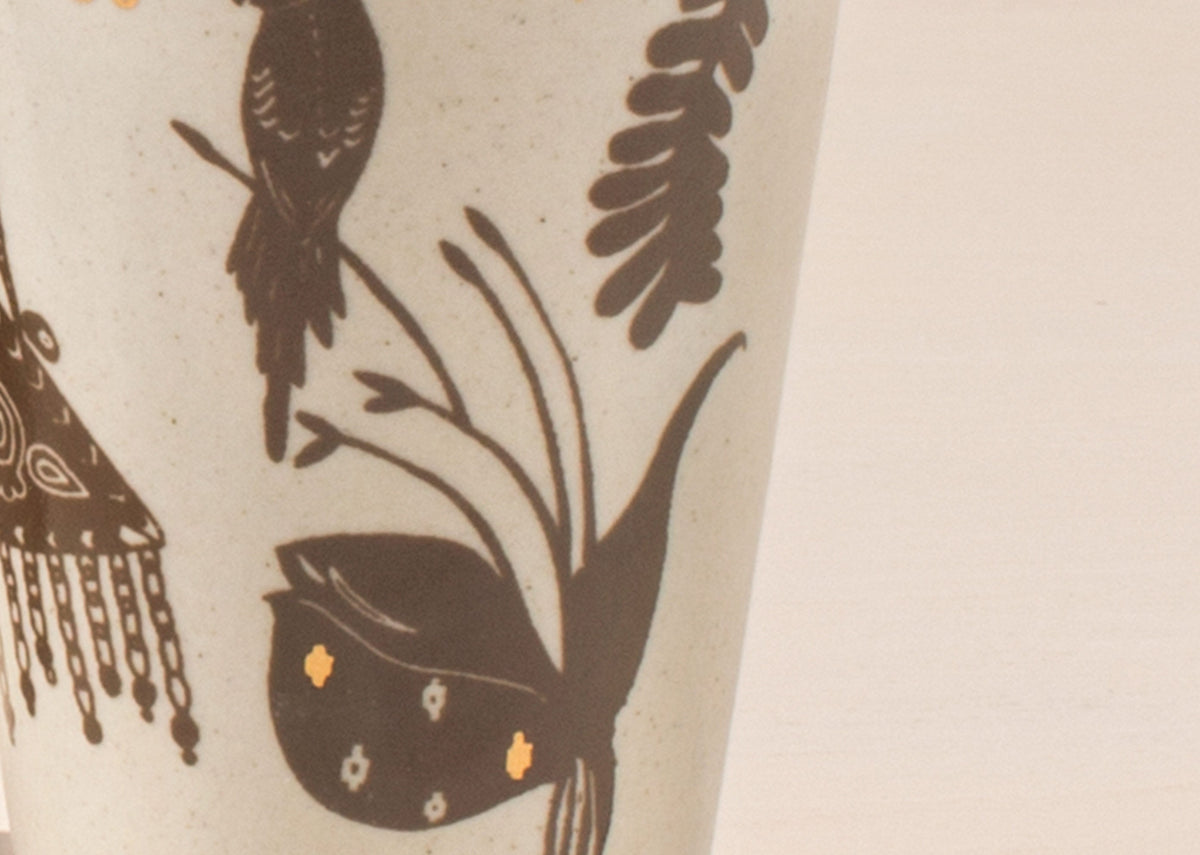 Close-up of a Desert Kulhar cup showing bird and leaf motifs.