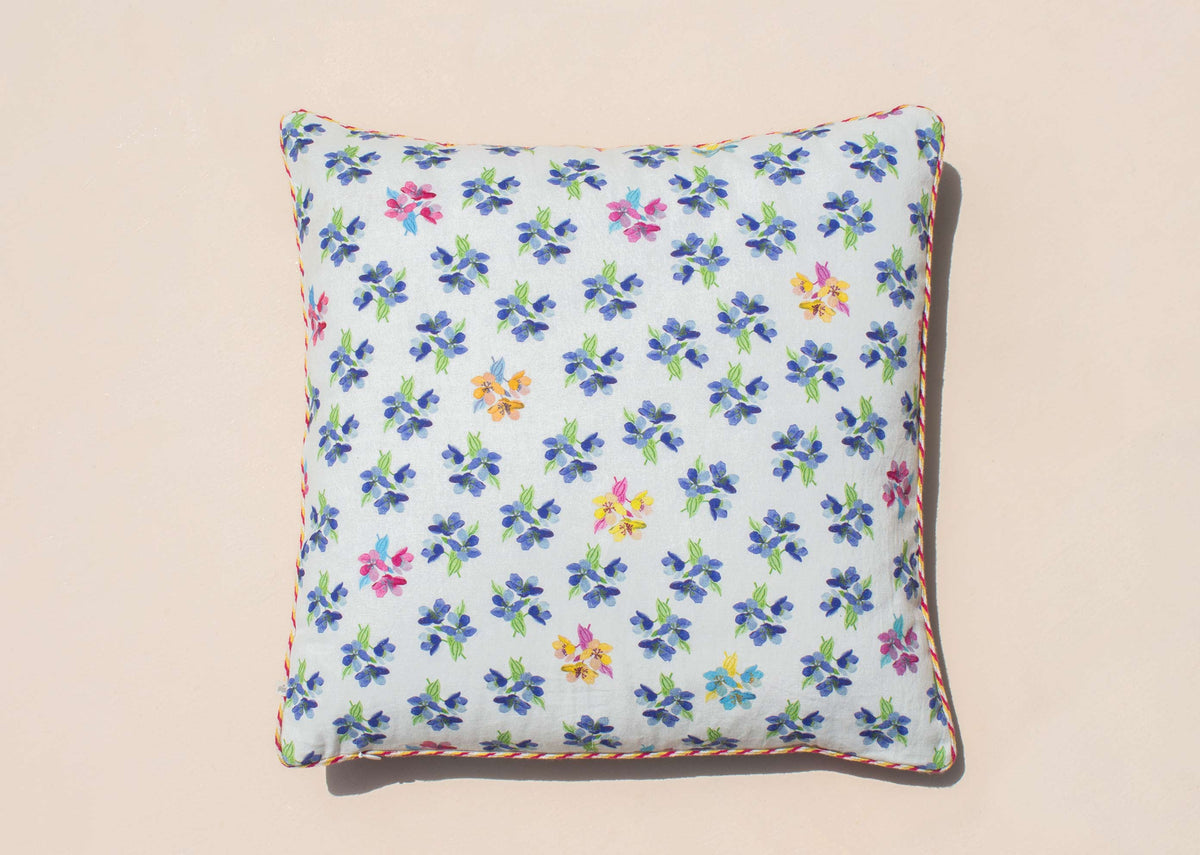 Mid Summer cushion cover in light blue with a small floral print.