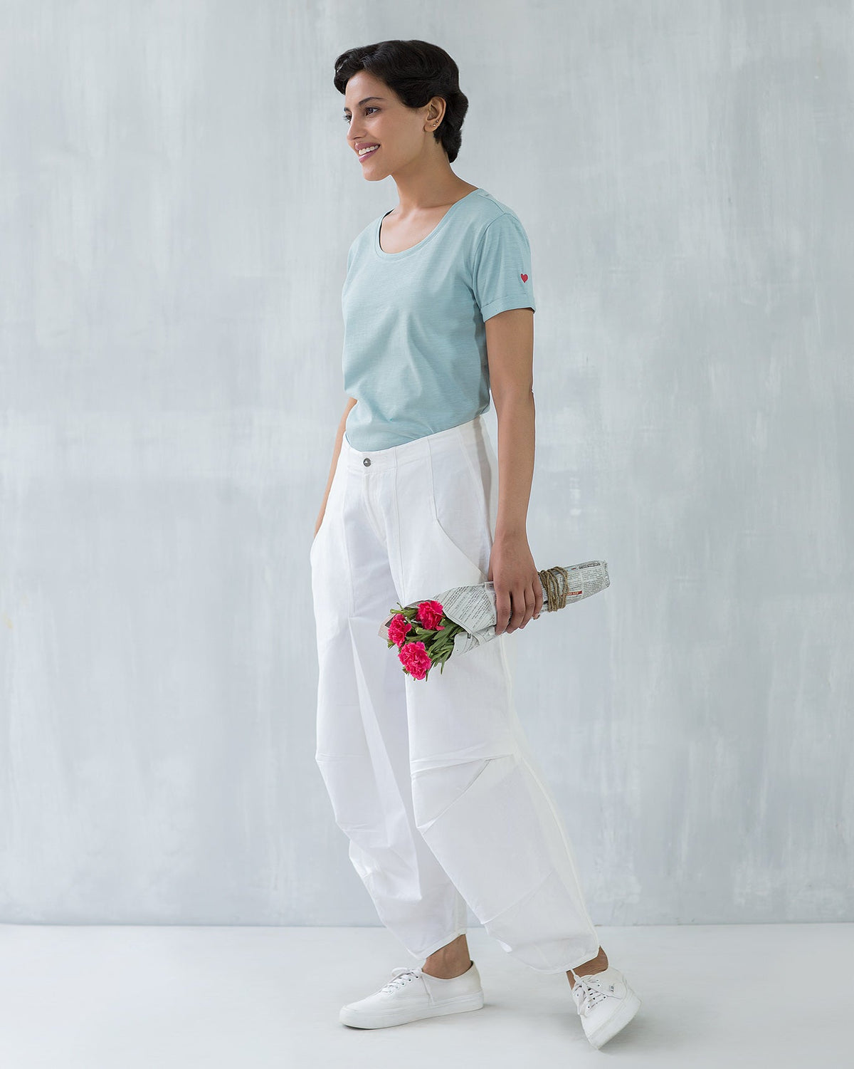 Person wearing a pale blue Basic T-shirt, standing full length.
