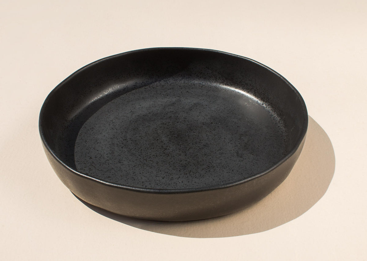 Desert Dusk Serving Dish in black, seen from an angle.