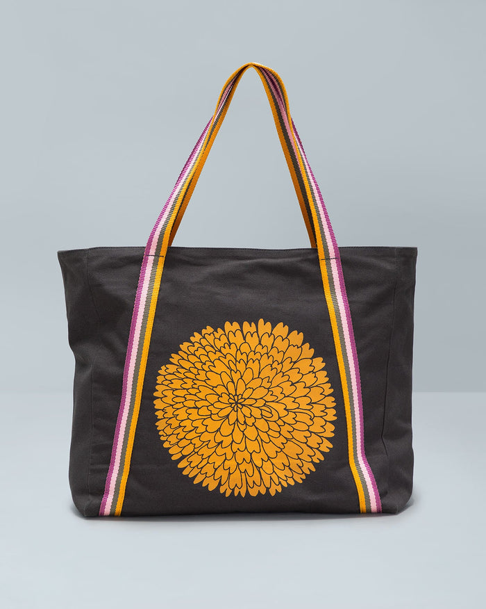 Marigold Tote with a mustard marigold print on dark canvas.