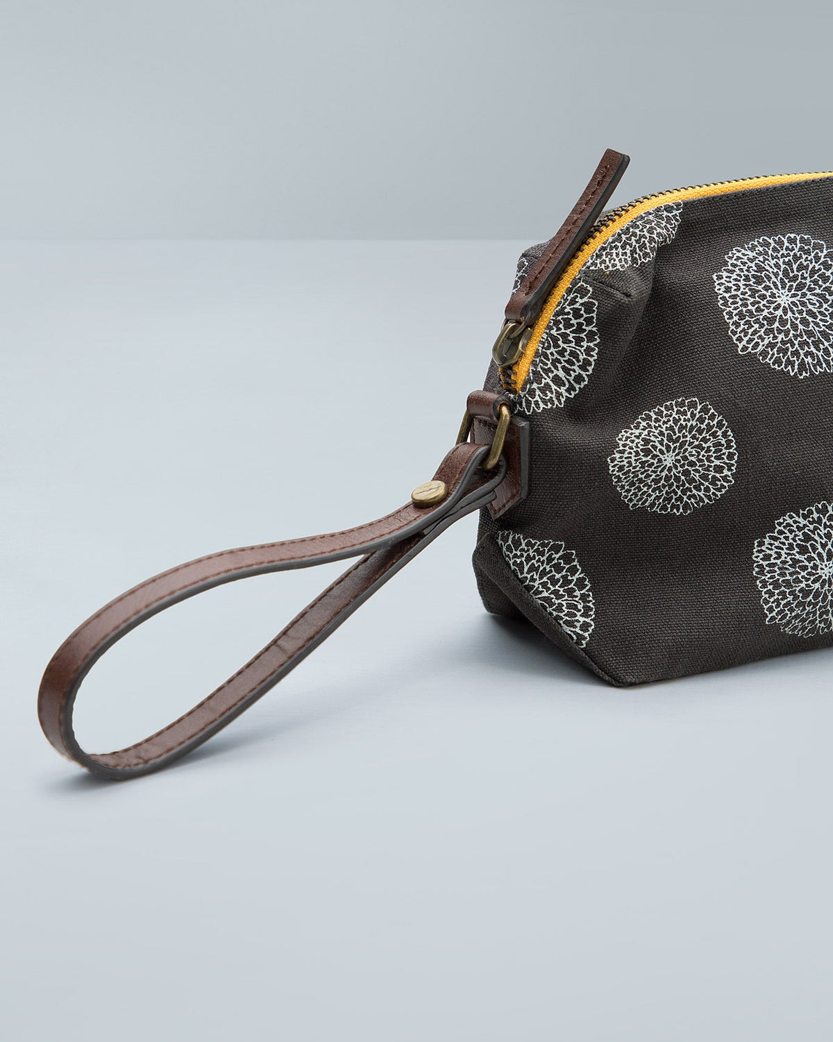 Close-up of Marigold Make-Up Pouch showing its yellow zip and leather wrist strap.