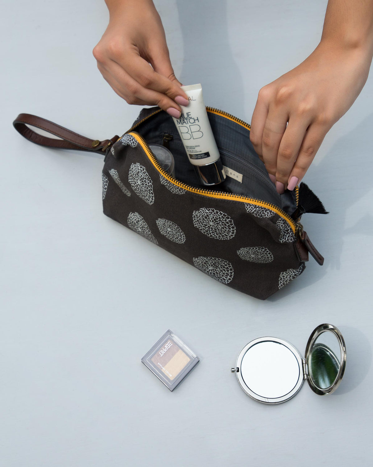 Marigold Make-Up Pouch open on a table with a tube inside.