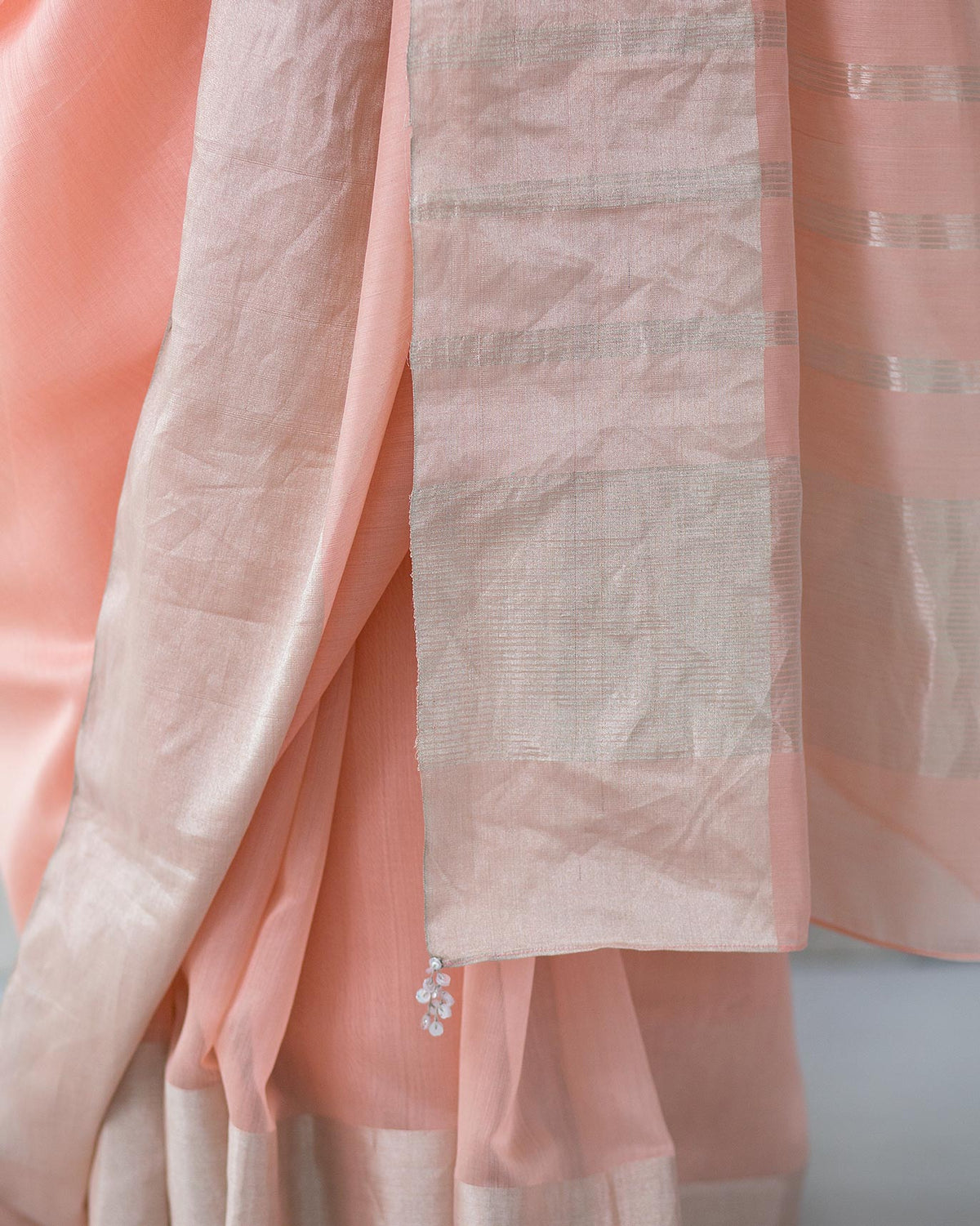 Close-up of a pink Serai Sari showing its striped border.