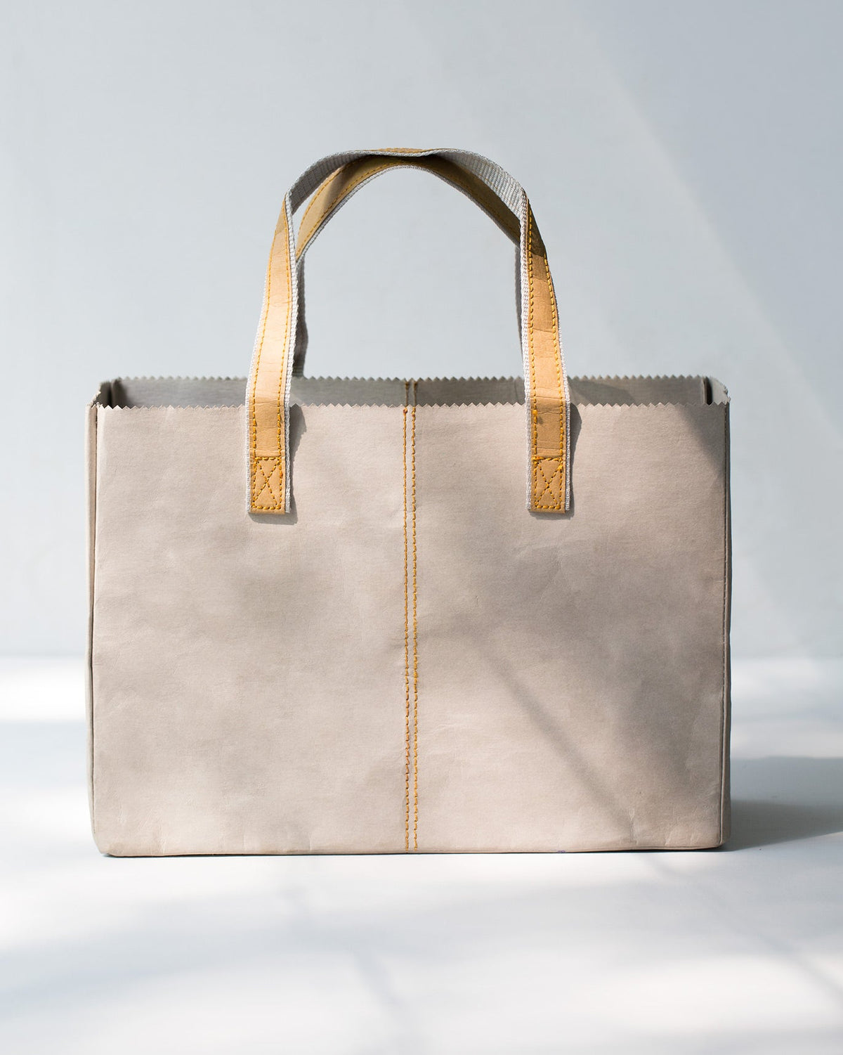 Back of Jawai Paper Tote with a yellow stitched seam.