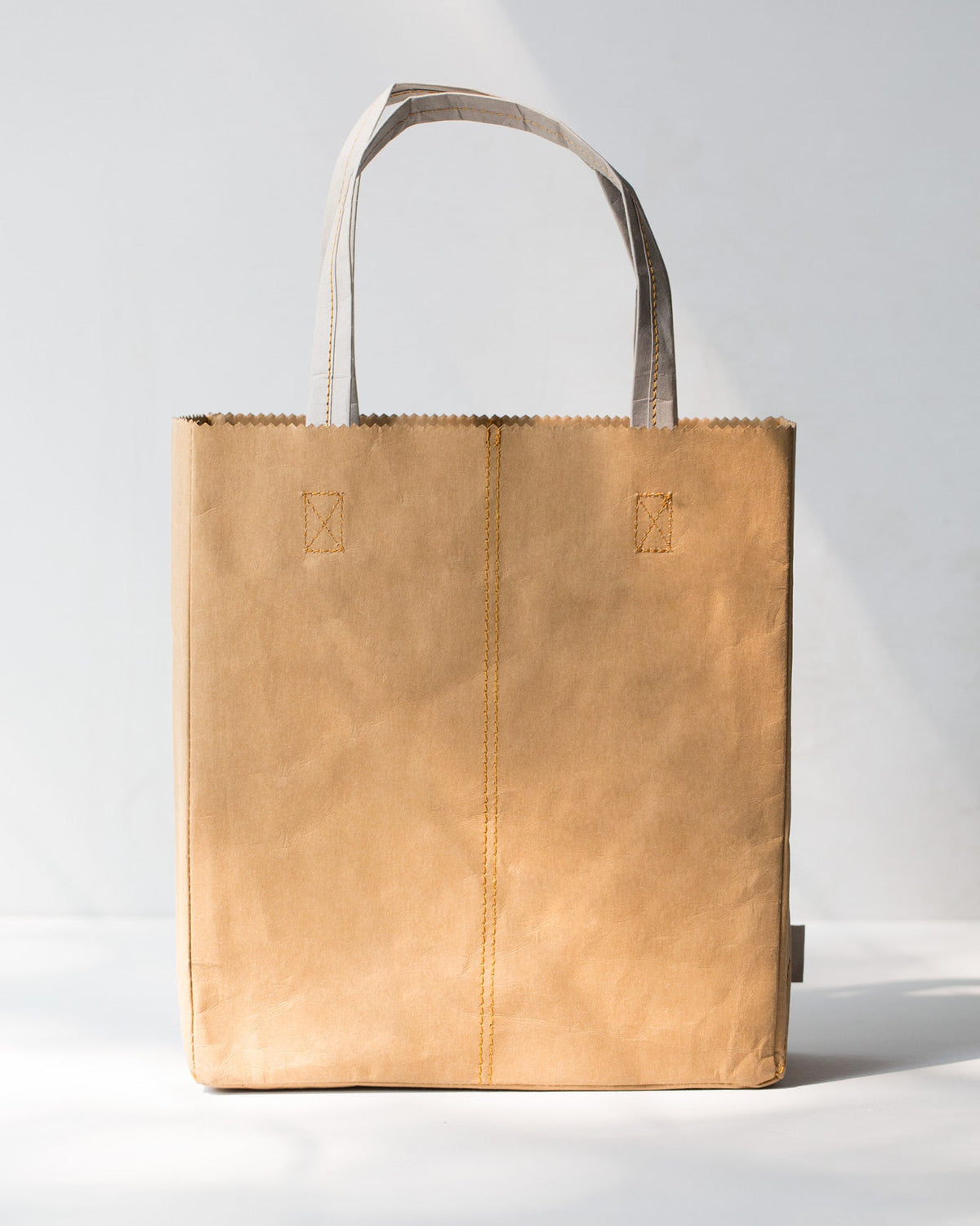 Back of the Sher Bagh Paper Tote, showing its stitched seam and handles.