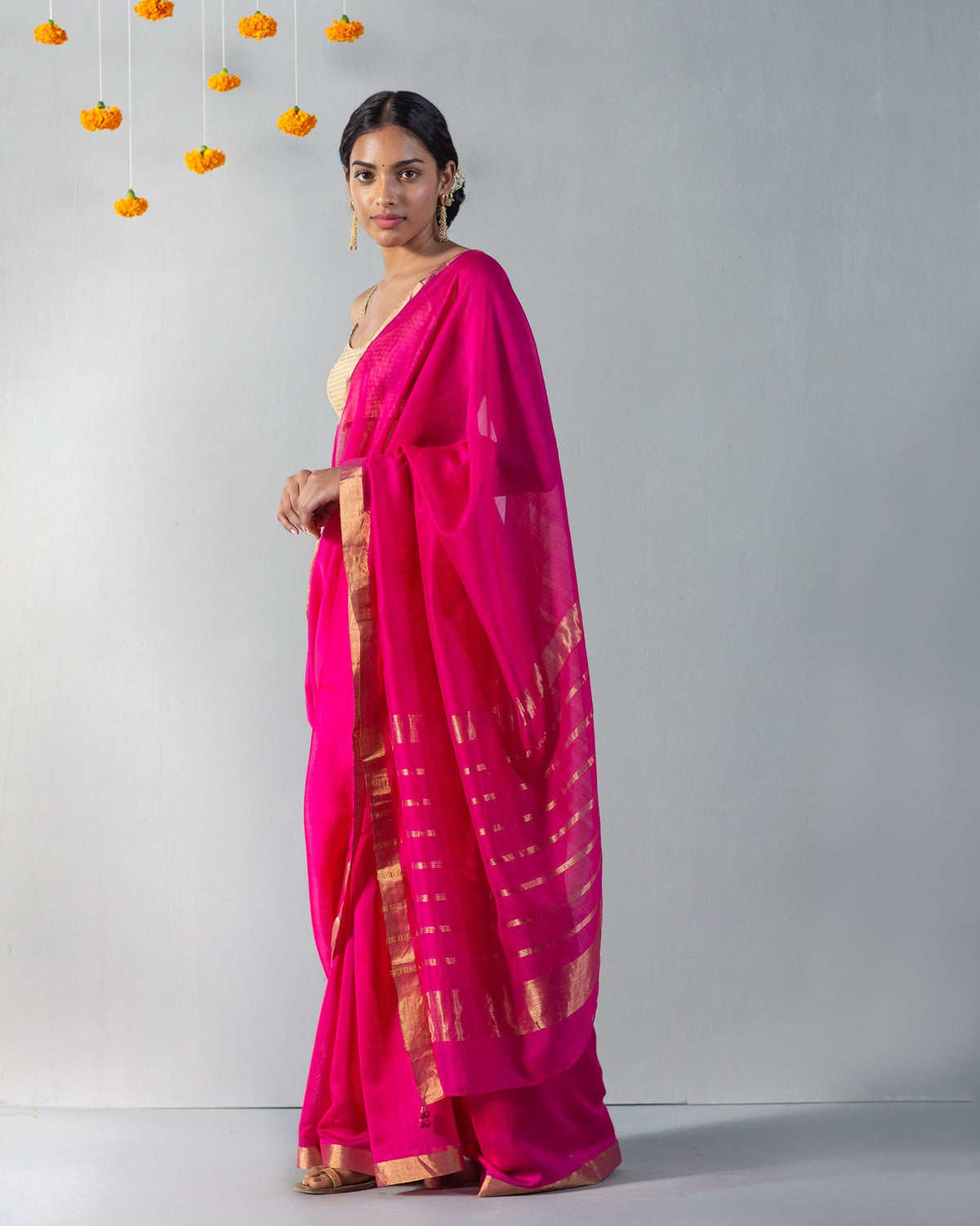 Side view of Kimsuka Sari with its gold-striped end draped over the arm.