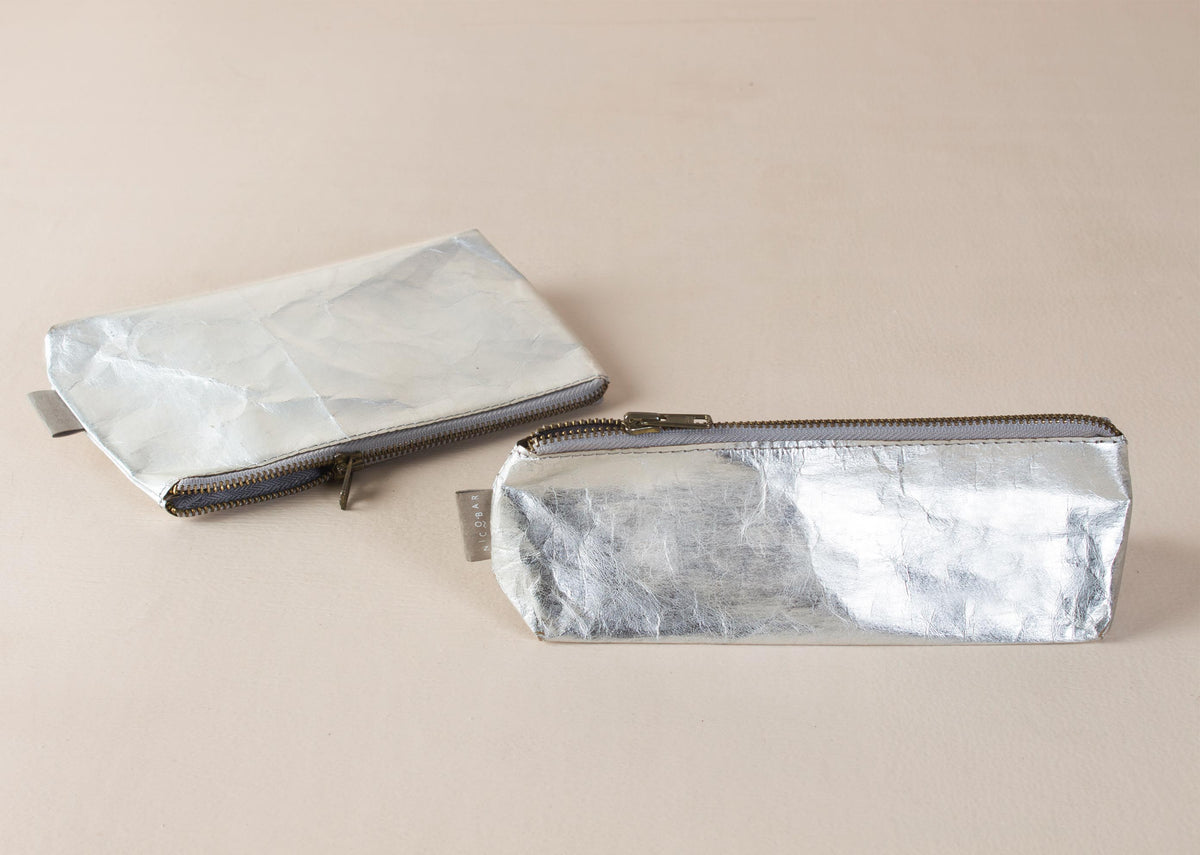 Silver Planet First Paper Pouches lying side by side, one flat and one long.