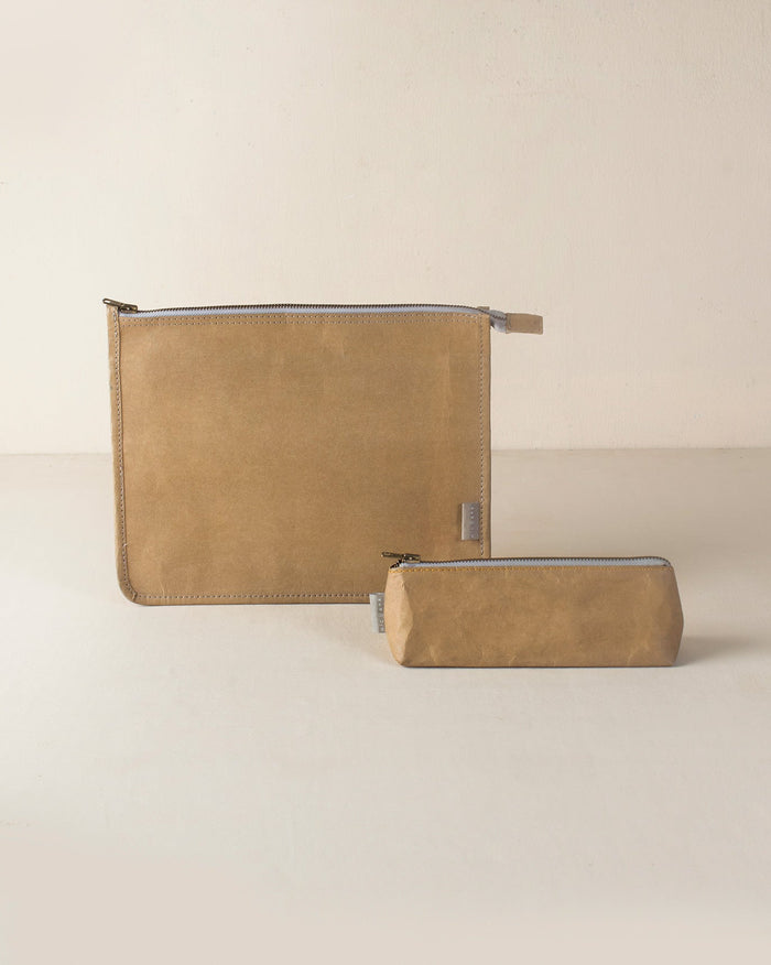 Brown Planet First Paper Pouches in two sizes, a flat zip pouch and a small boxy one.