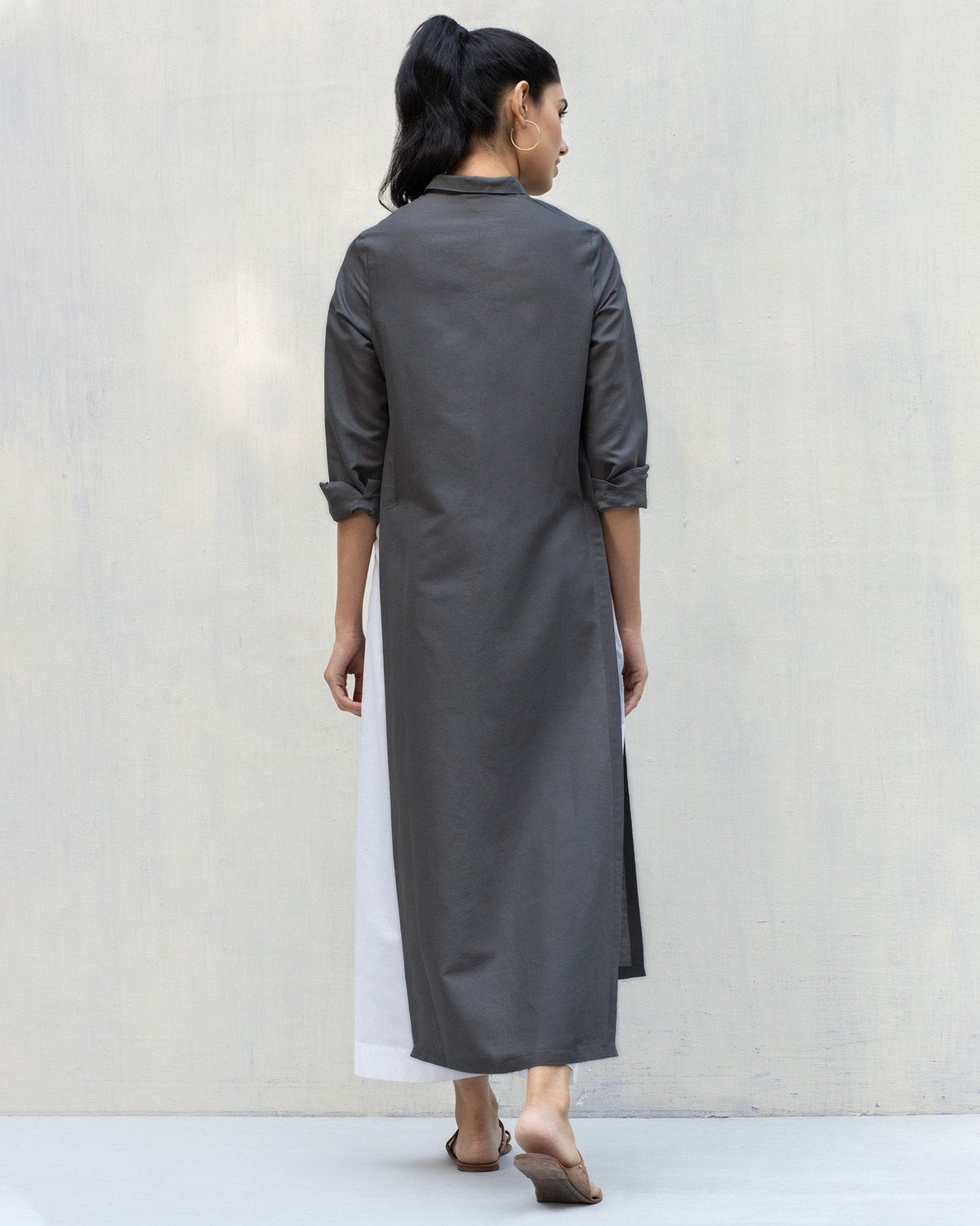 Back of a charcoal Many Moons Kurta with a long straight hem, worn by a person.