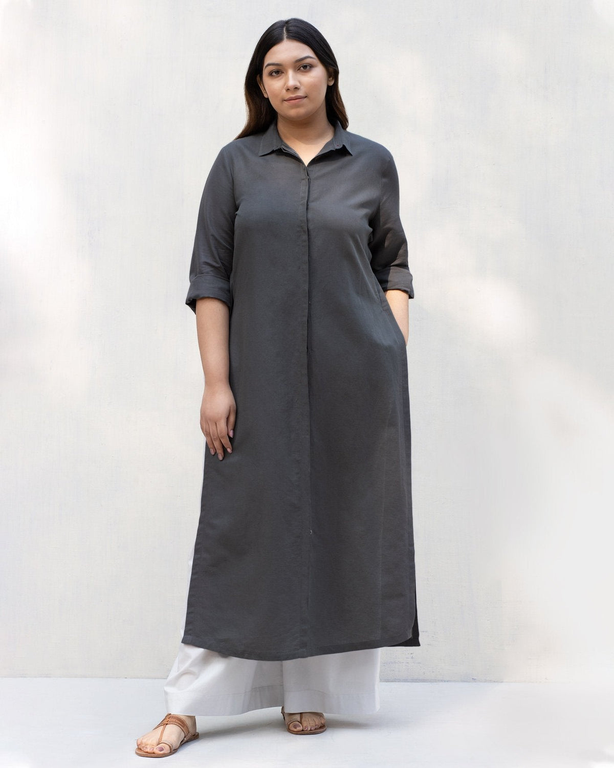 Person standing in a long charcoal Many Moons Kurta with a collared neck.