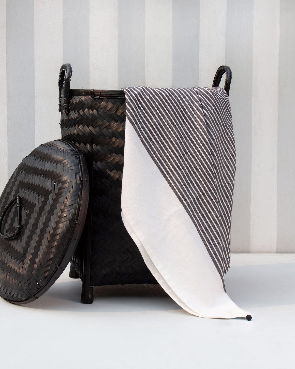 Stripe Beach Throw draped over a woven basket, showing its white end panel.