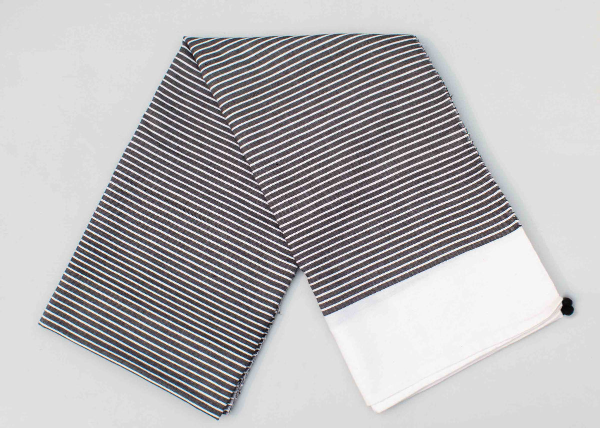 Stripe Beach Throw folded flat, showing its fine stripes and white end panel.