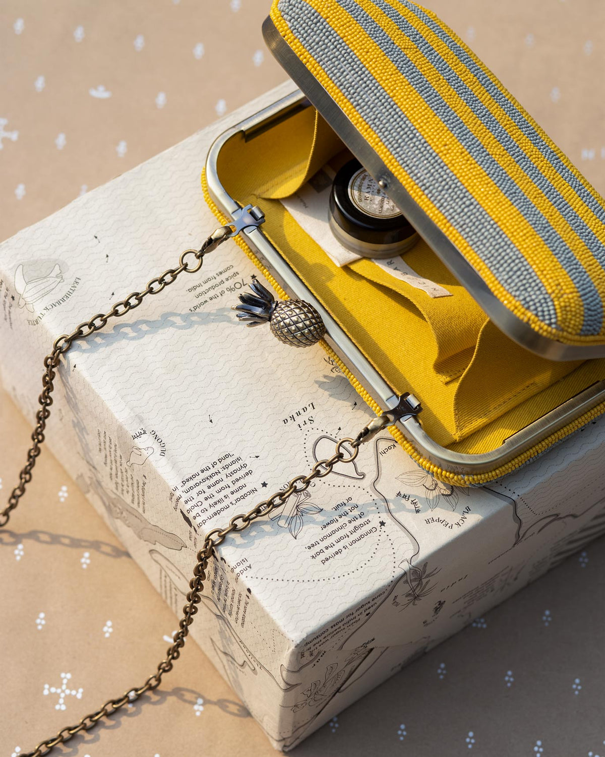 Ananas clutch open to show its yellow lining.