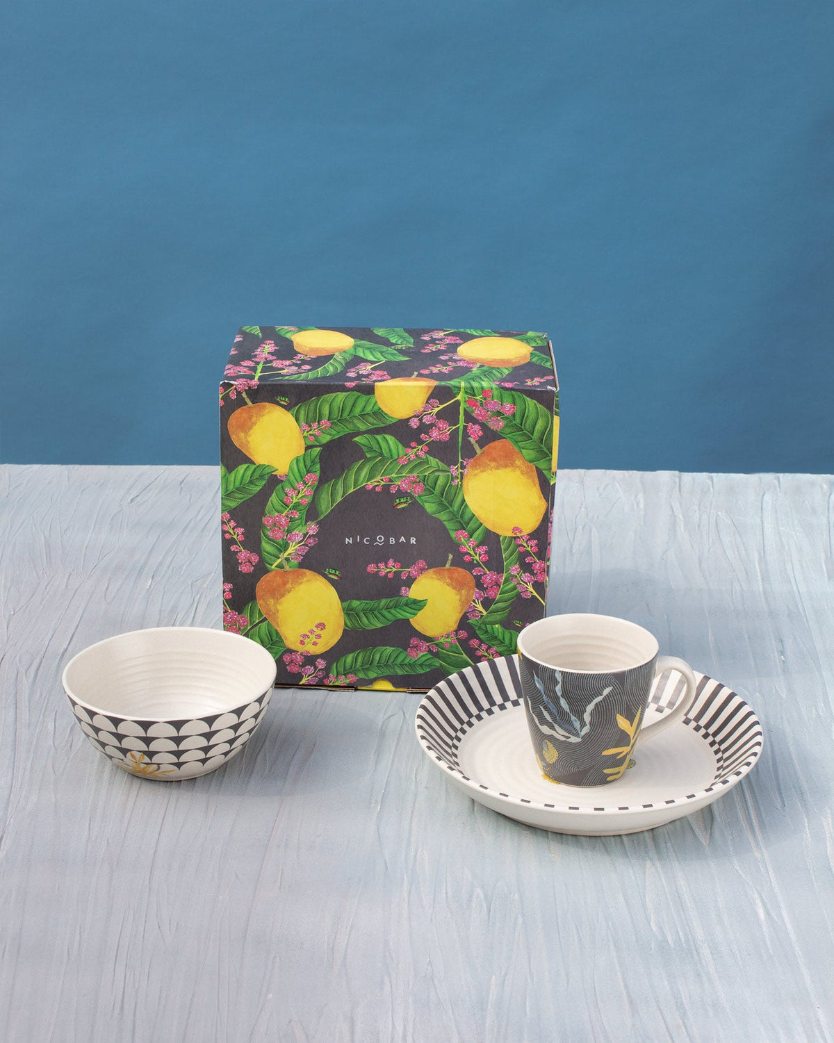 Champa Breakfast Set with a lemon-print box behind, showing the bowl, mug and plate.