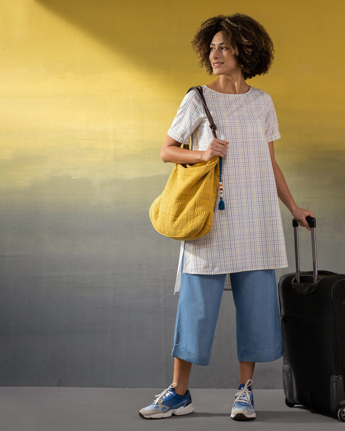 Person carrying the Nomad Tote on one shoulder.
