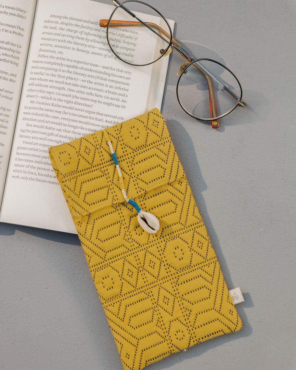 Yellow Jacquard Spectacle Case shown with a pair of glasses.