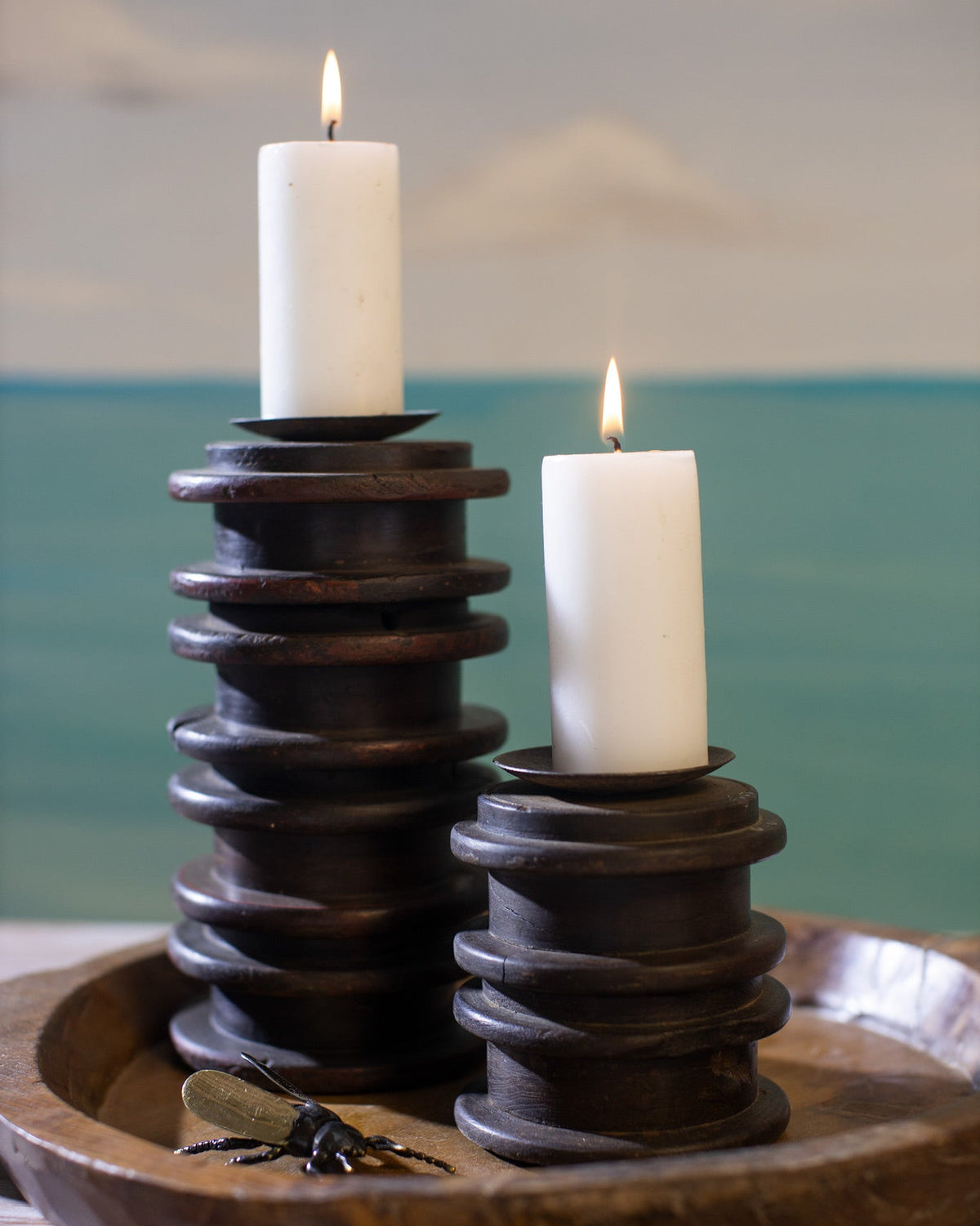 Wood Fire Candle Holders - Medium holding two lit white candles.