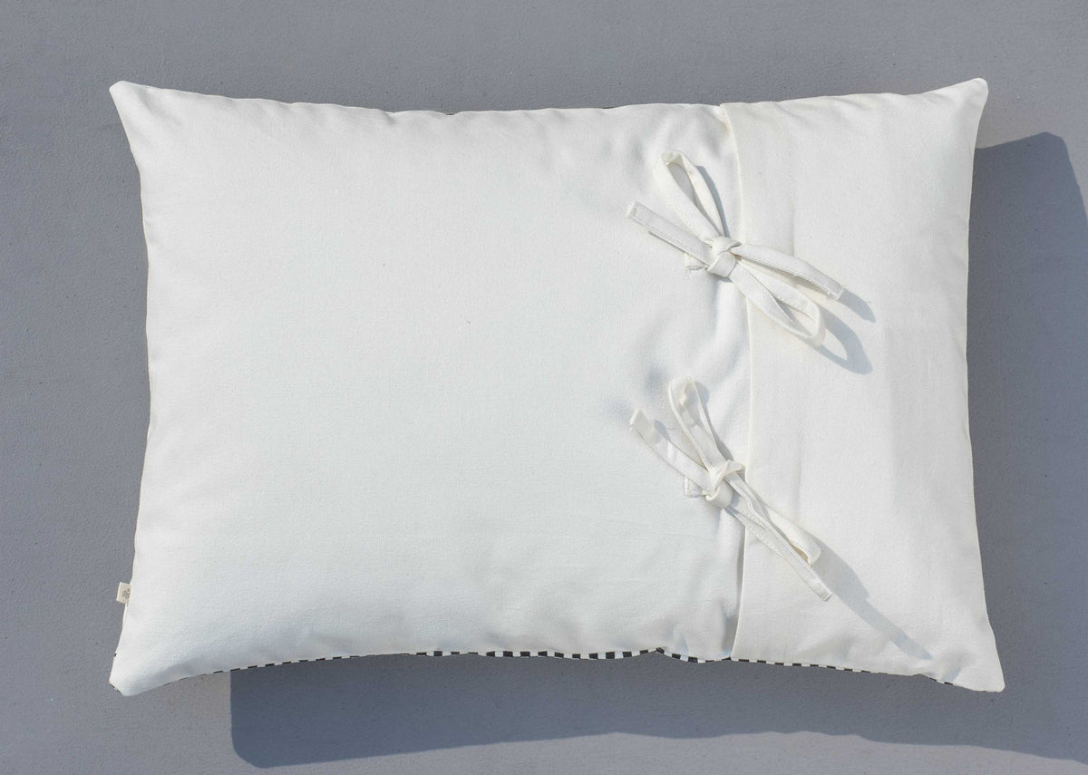 Check Stripe Lumbar Pillow Cover in plain white with ribbon ties at the side.