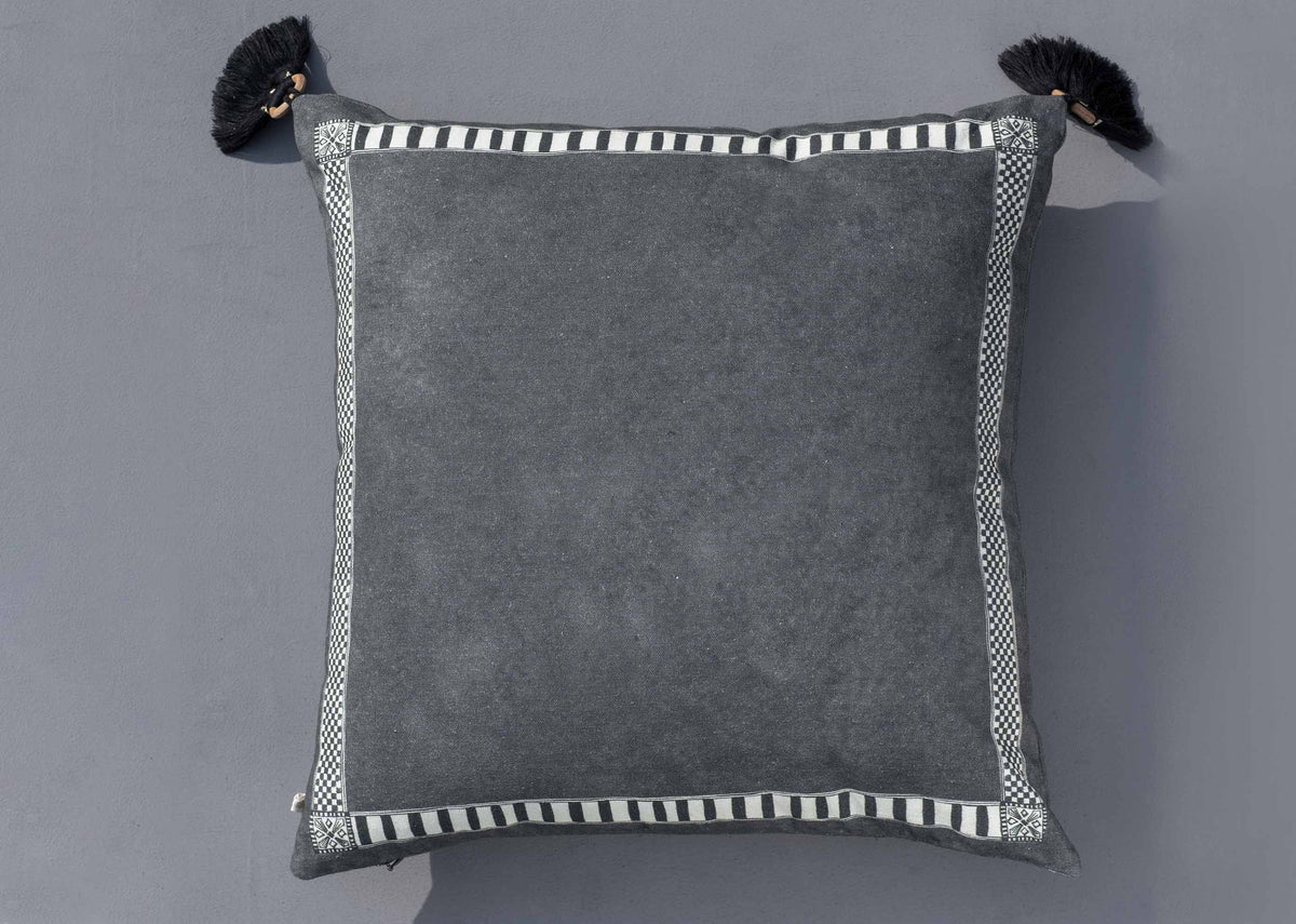 Back of an Aam Trium Cushion Cover, plain charcoal with a striped border.