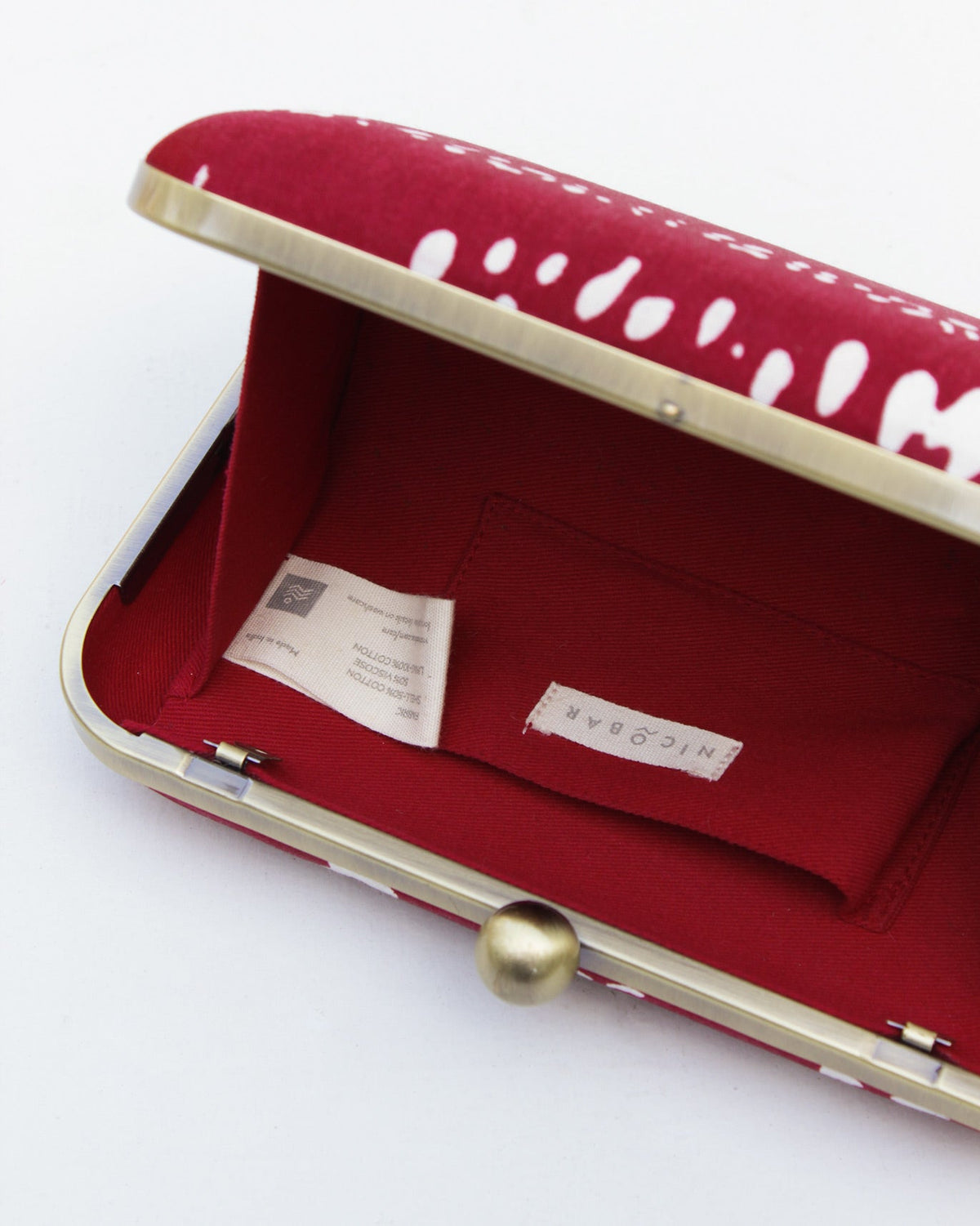 Open Martini Clutch showing its red interior and NICOBAR label.