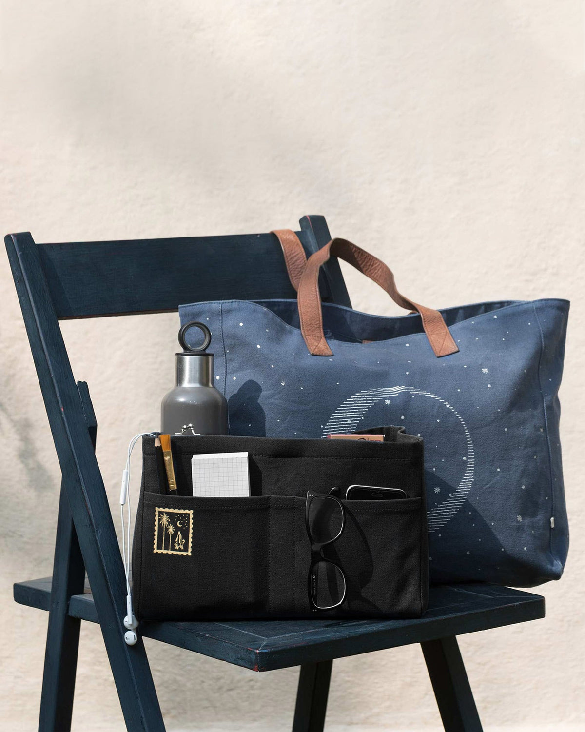 Black Musafir Zenbu organiser with a notebook and glasses inside.