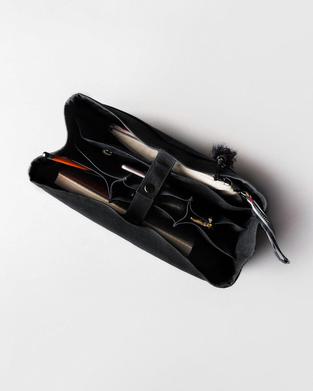 Open black Musafir Zenbu organiser with brushes and pens inside.