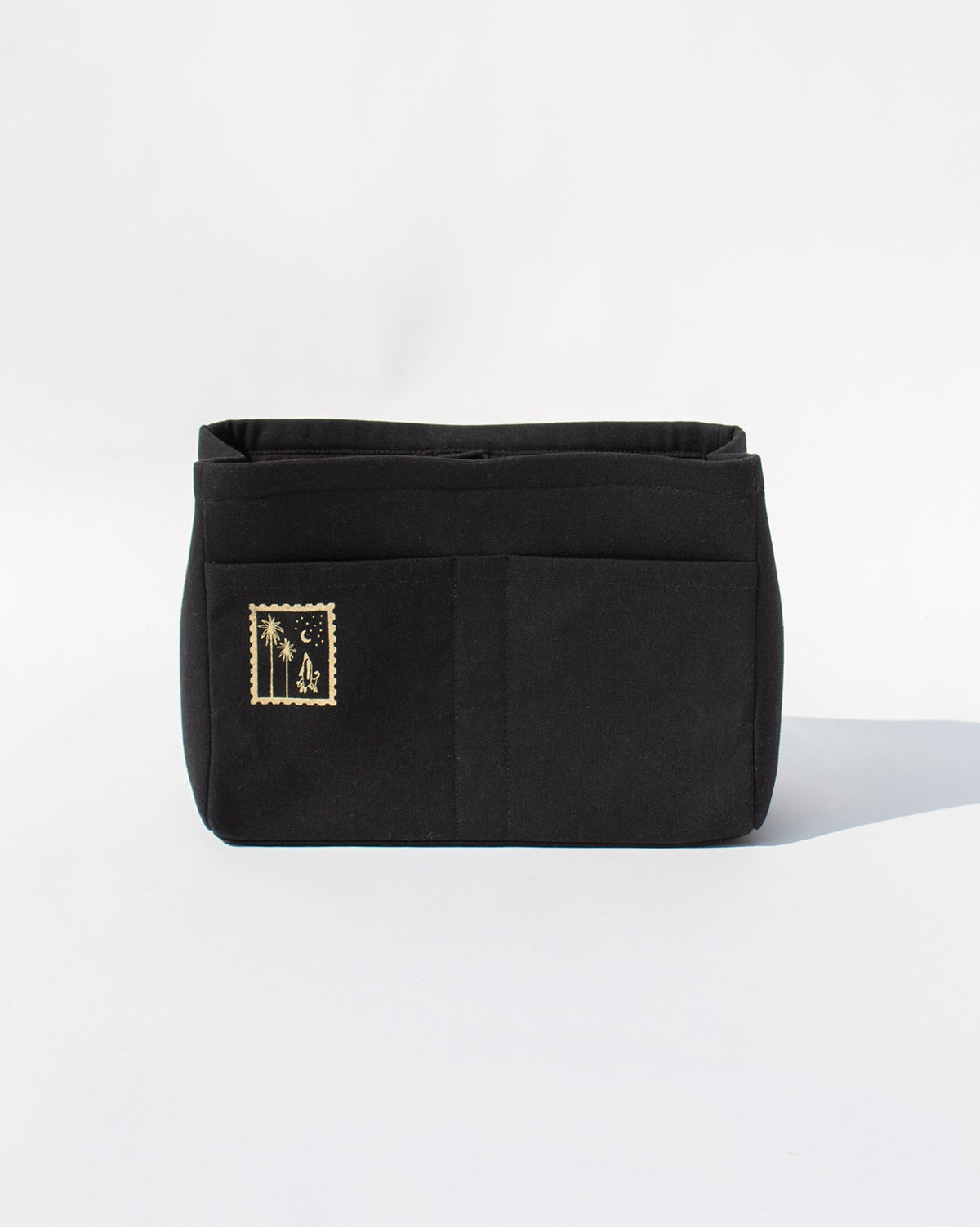 Front of a black Musafir Zenbu organiser with a palm and moon patch.