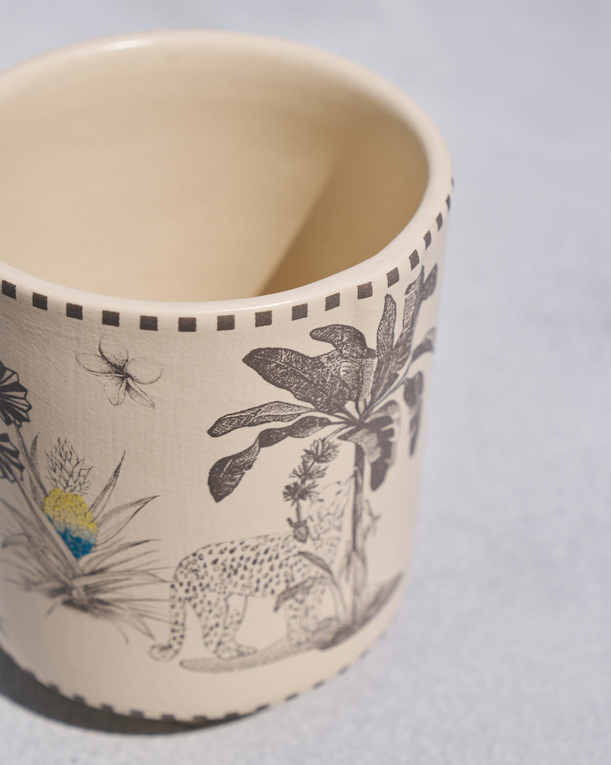 Close-up of a leopard and palm print on a Monchrome planter.
