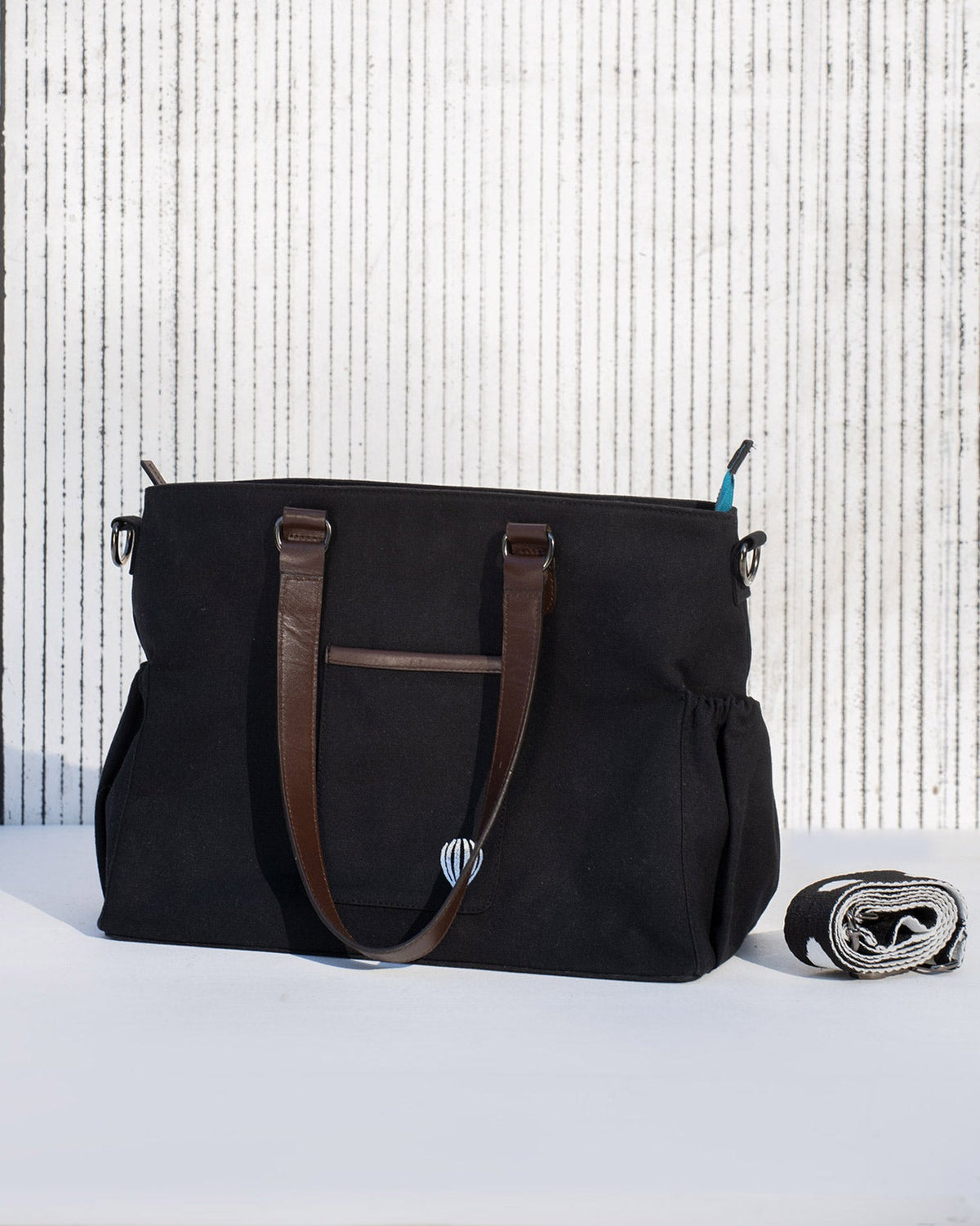 Side view of the Perfect Work Bag showing its side pockets and handles.