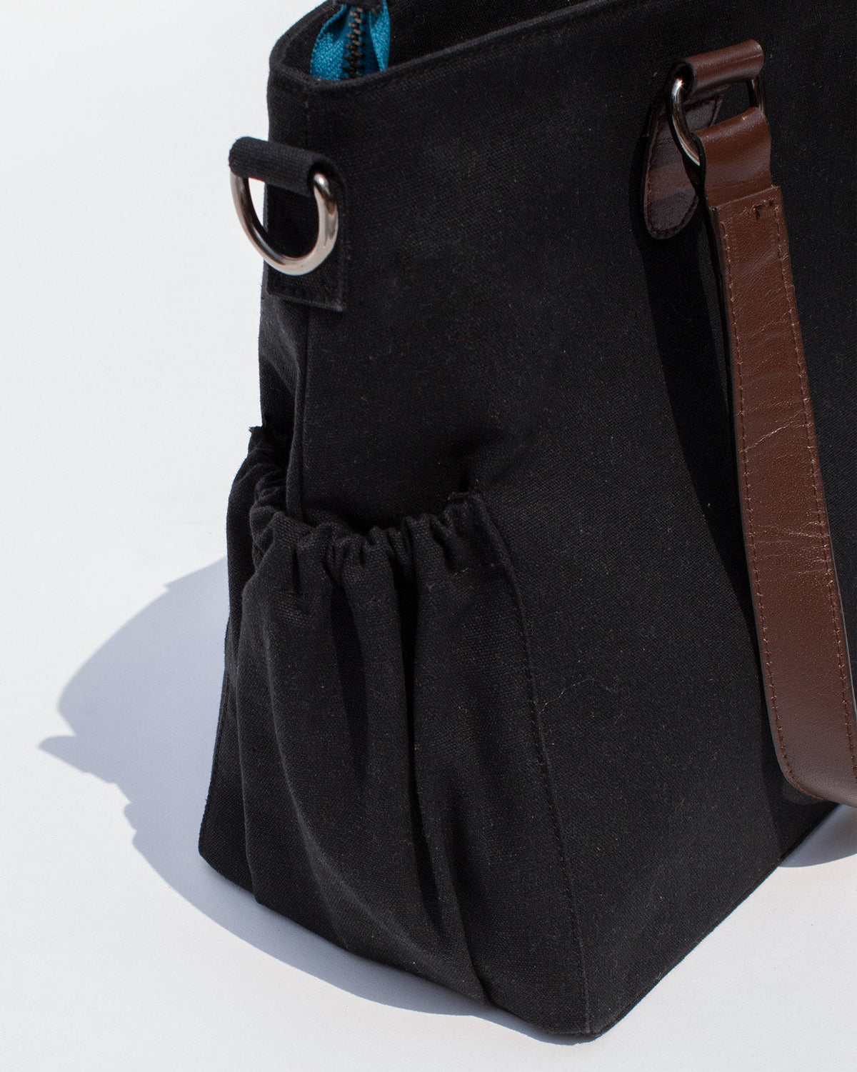 Close-up of the Perfect Work Bag's gathered side pocket and leather handle.