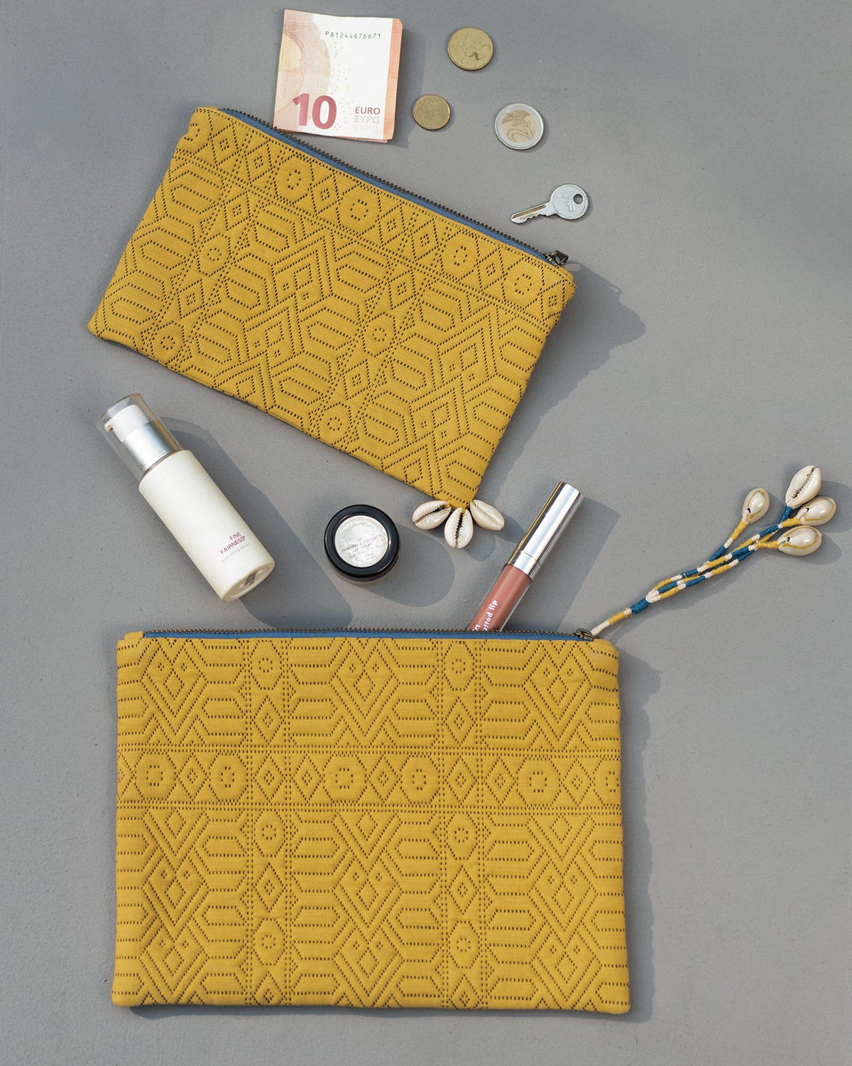 Jumbo Jacquard Pouch in yellow shown beside a smaller matching pouch.