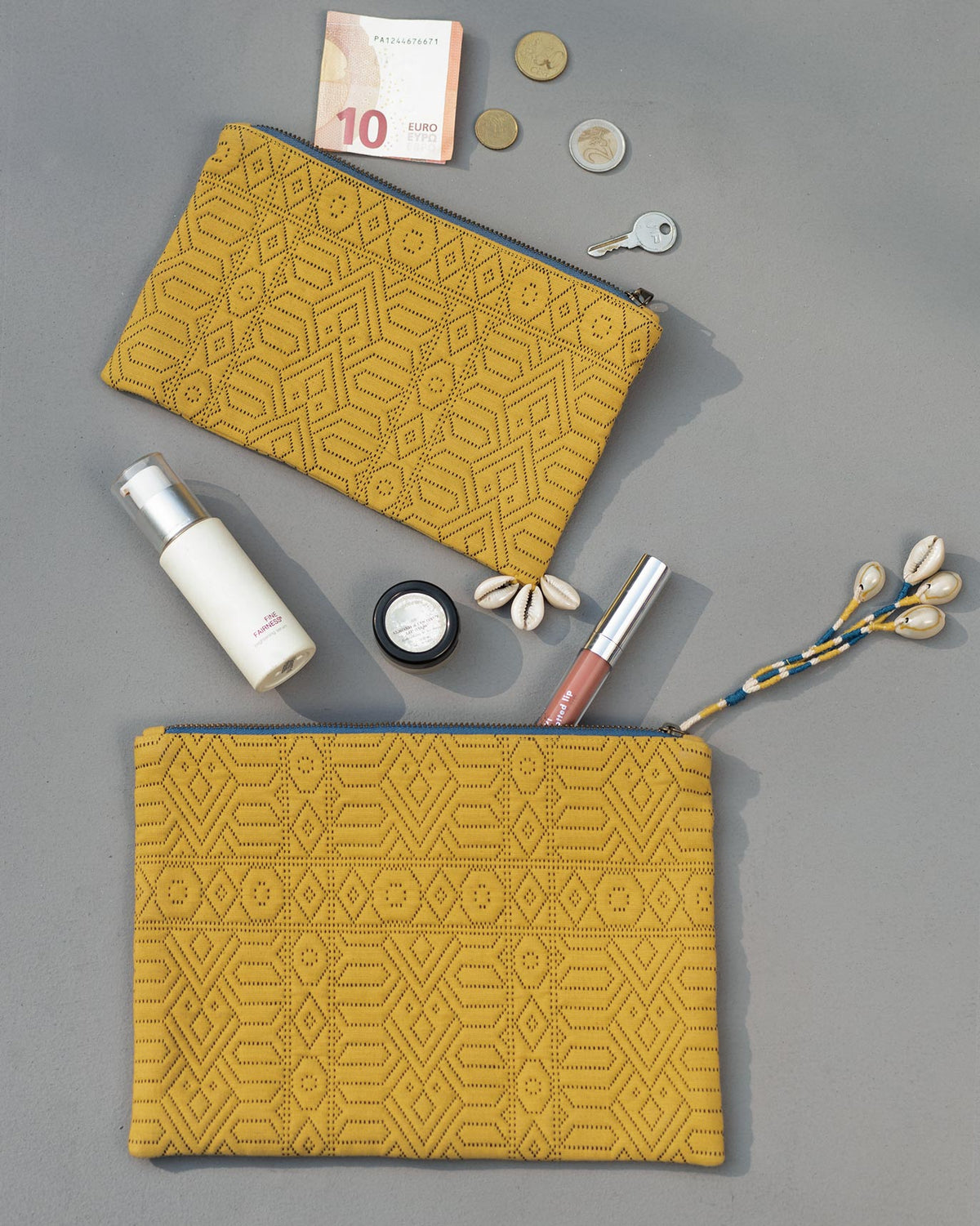 Pair of yellow Midi Jacquard Pouches laid flat in two sizes.