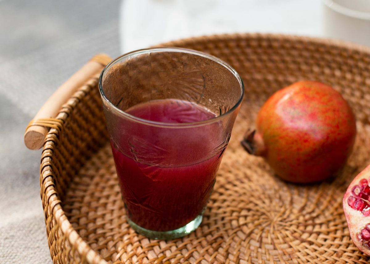 Aire Water Tumbler filled with a red drink.
