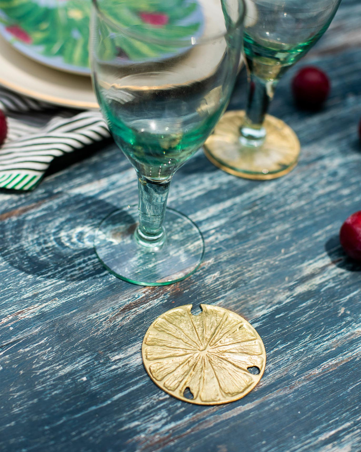Dawa Coaster set on a table beside glassware.