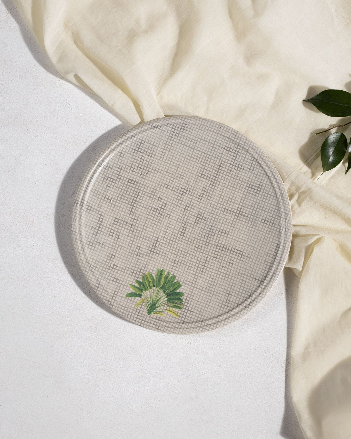 Overhead view of Madagascar dinner plate with crosshatch and palm leaf.