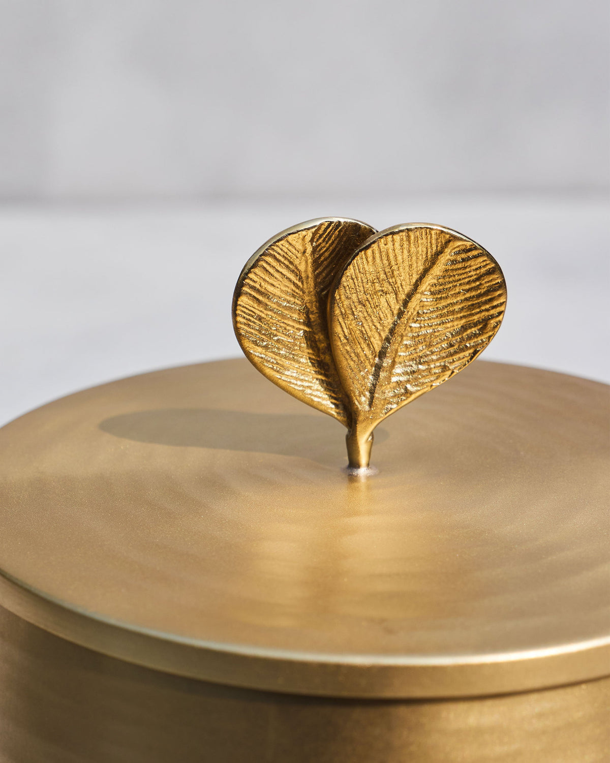 Close-up of the leaf finial on a Champa gold ice bucket lid.