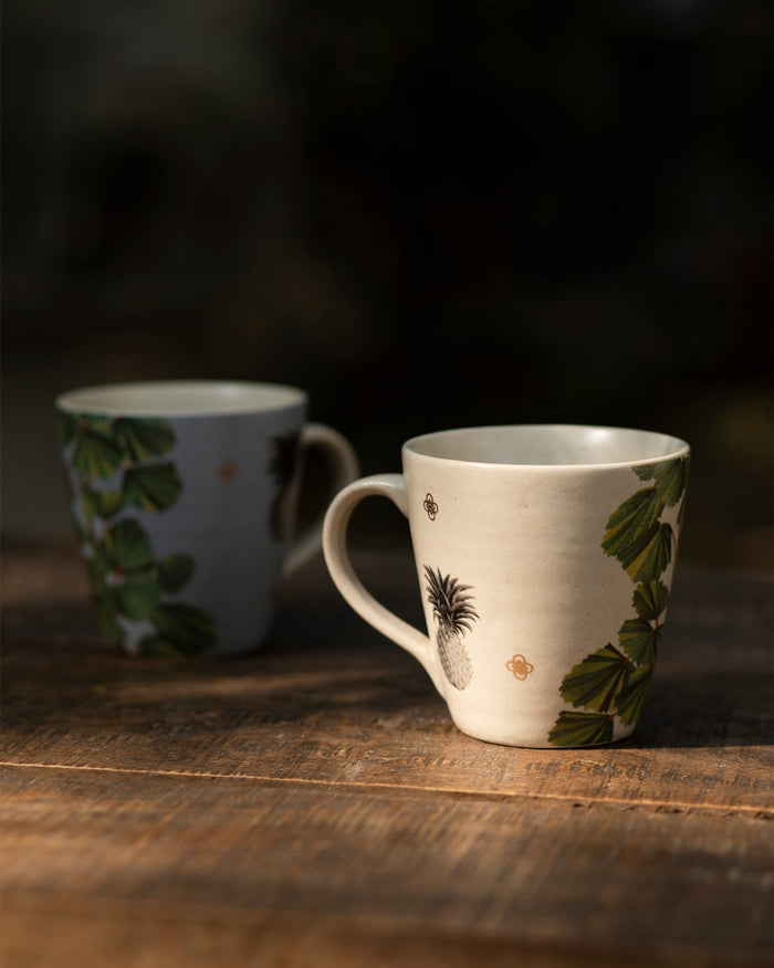 Oyster Bay Mug Set with pineapple and leaf motifs in cream and grey.