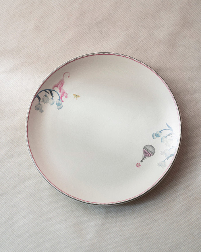 Cream Myra dinner plate with a pink animal, blue flowers and a hot-air balloon.