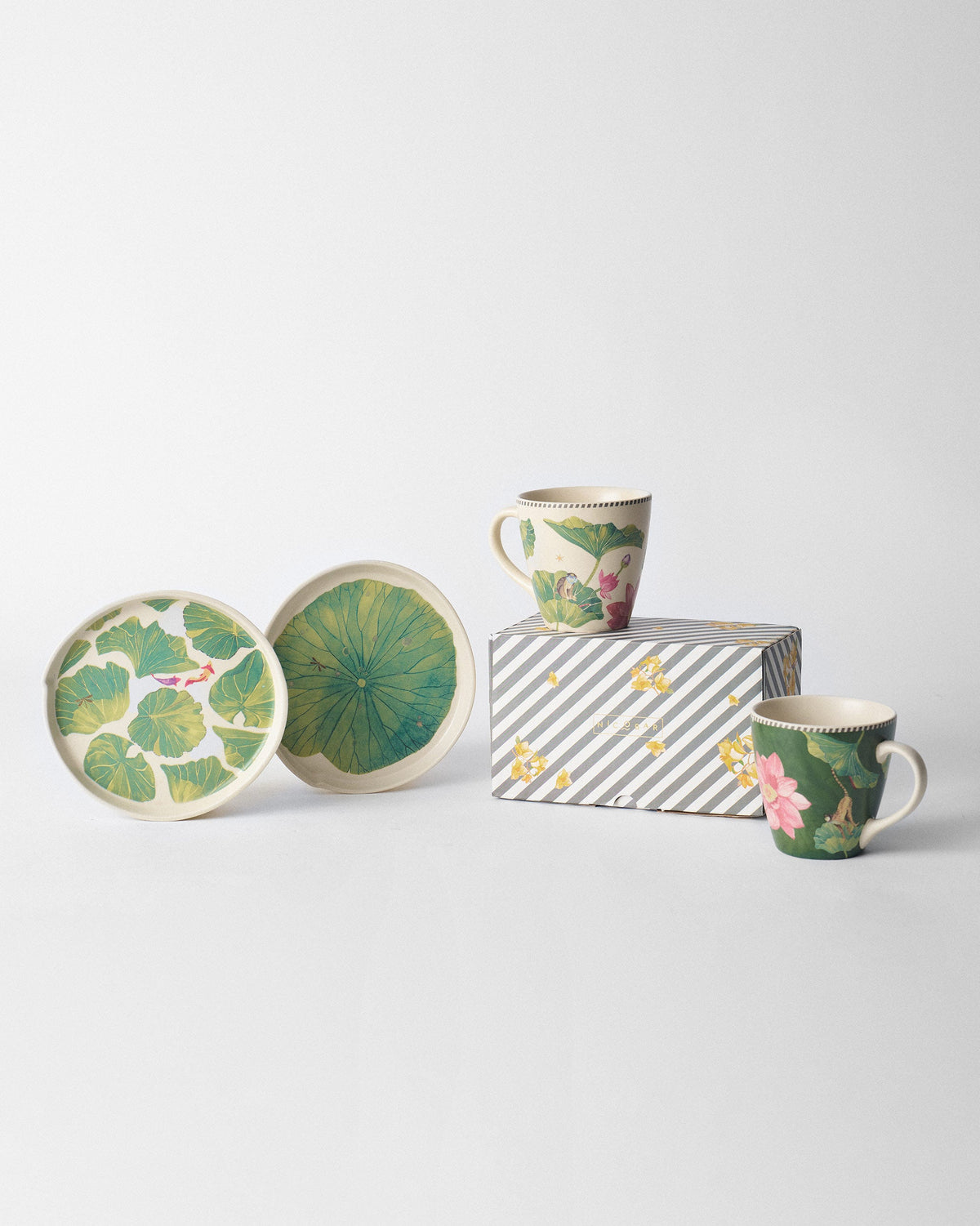 Float conical mugs arranged with lotus plates and a gift box.