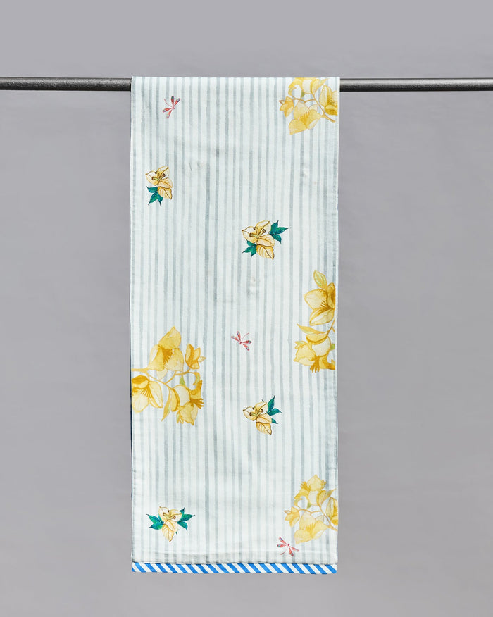 Bagan table runner with yellow flowers on a grey and white striped ground.